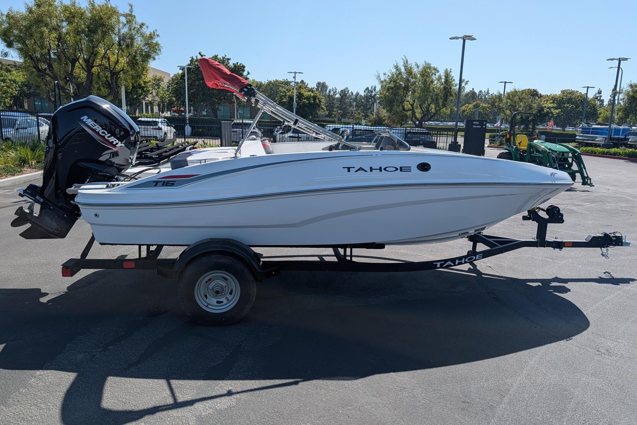 2026 Tahoe T16 boat on trailer with Mercury outboard motor, parked outdoors.