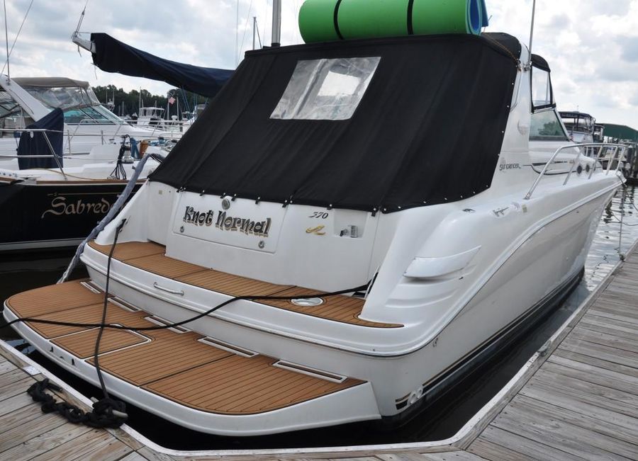 1998 Sea Ray Sundancer 370 docked with black cover.