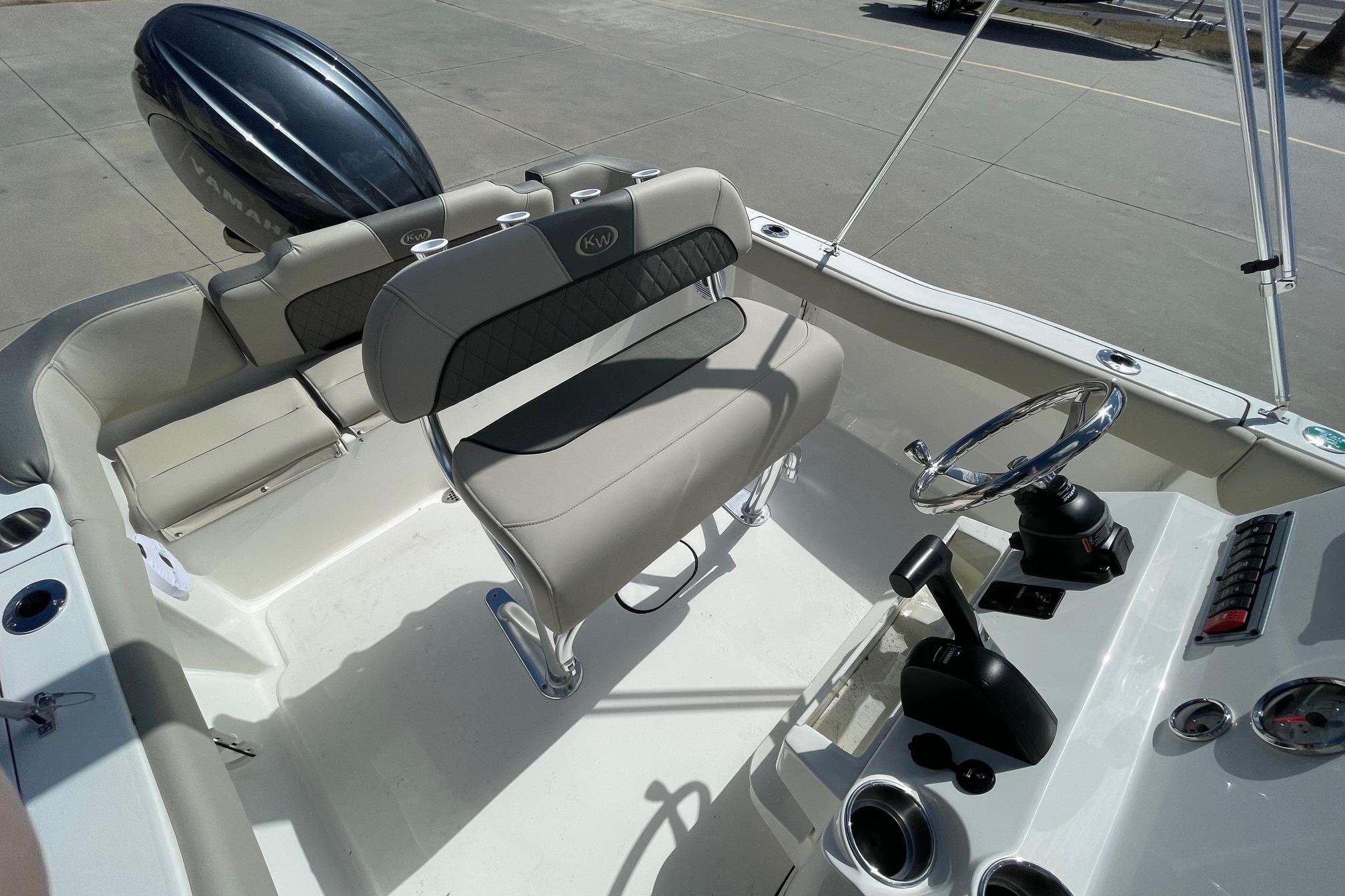 2026 Key West 203 FS boat interior with steering wheel and seating.