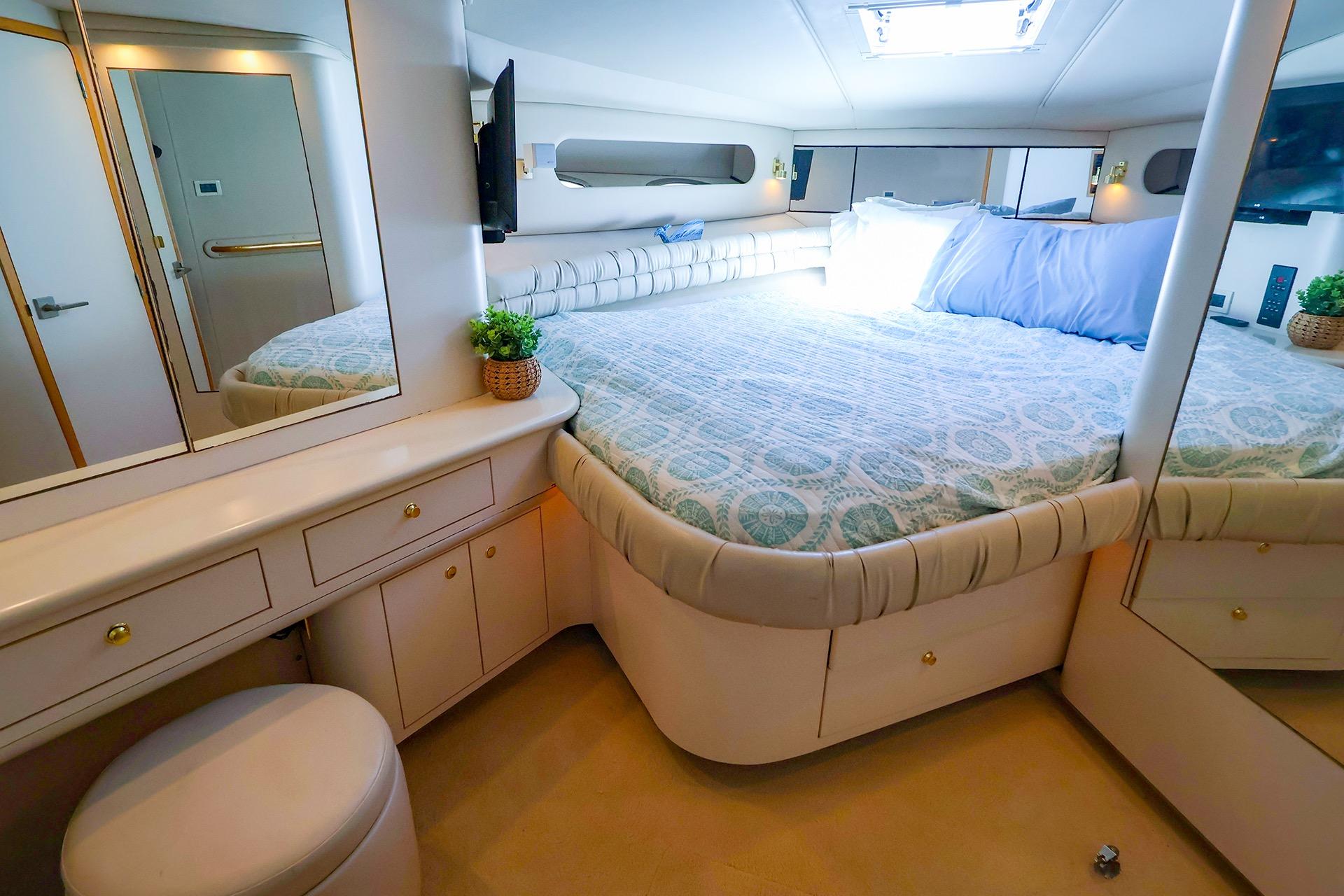 Luxurious bedroom interior of 1998 Sea Ray 500 Sundancer yacht with elegant furnishings.