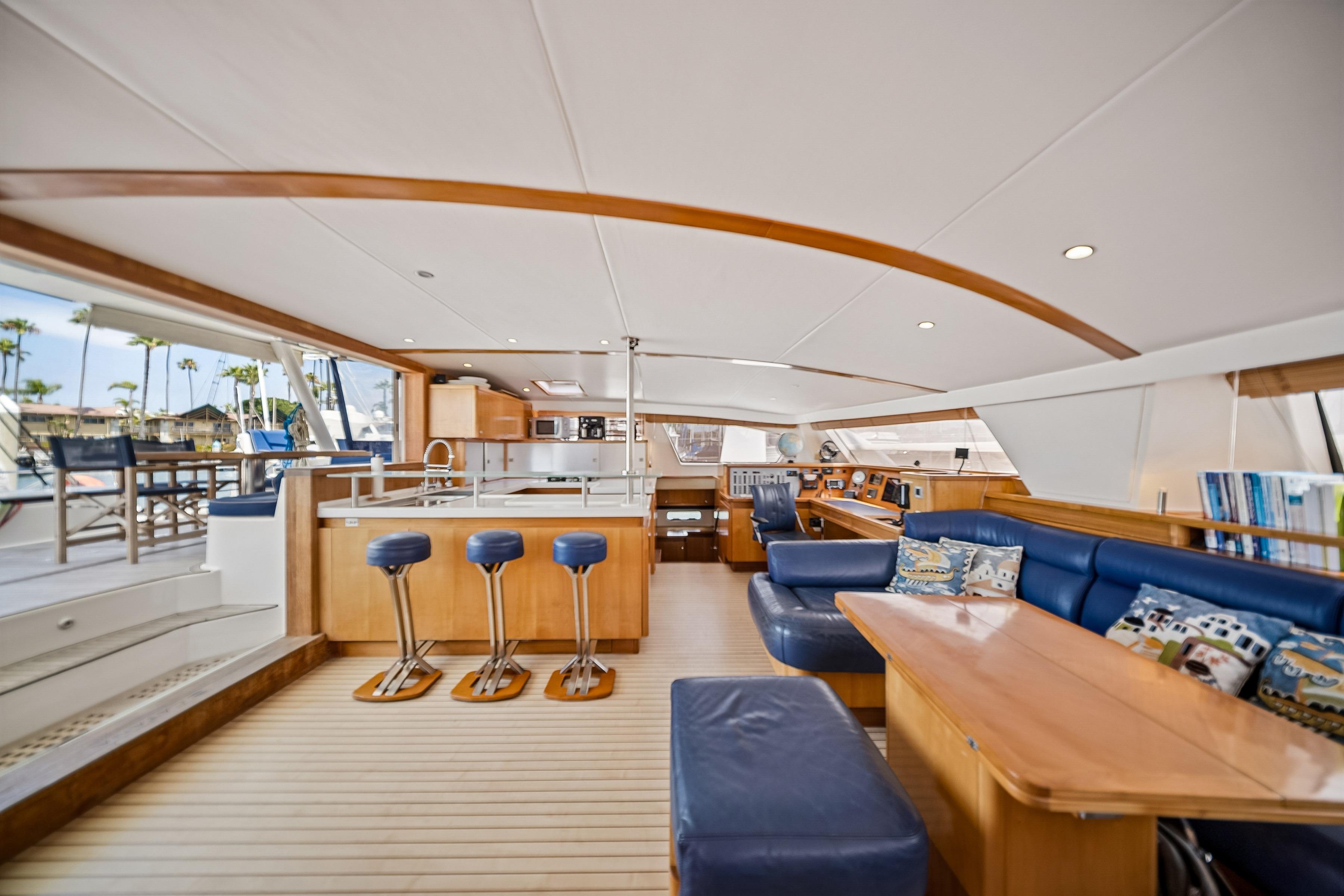 Luxurious interior of 2009 Catana 65 yacht with modern seating and dining area.