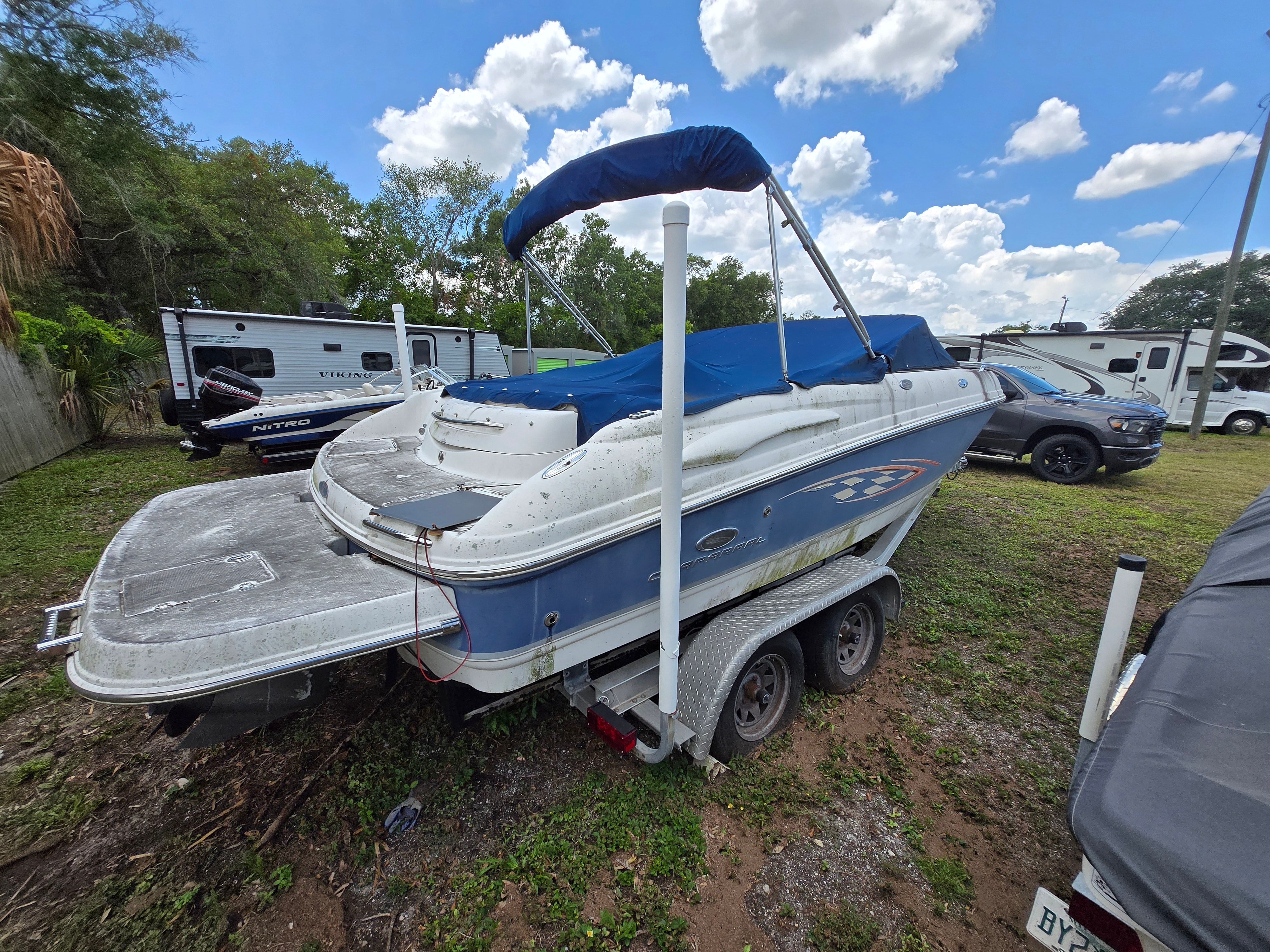 A 2006 Chaparral 220 SSi boat is on a trailer outdoors.