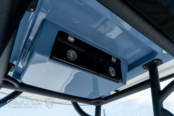 2025 Caymas 281 HB boat console detail with blue finish and storage compartment.