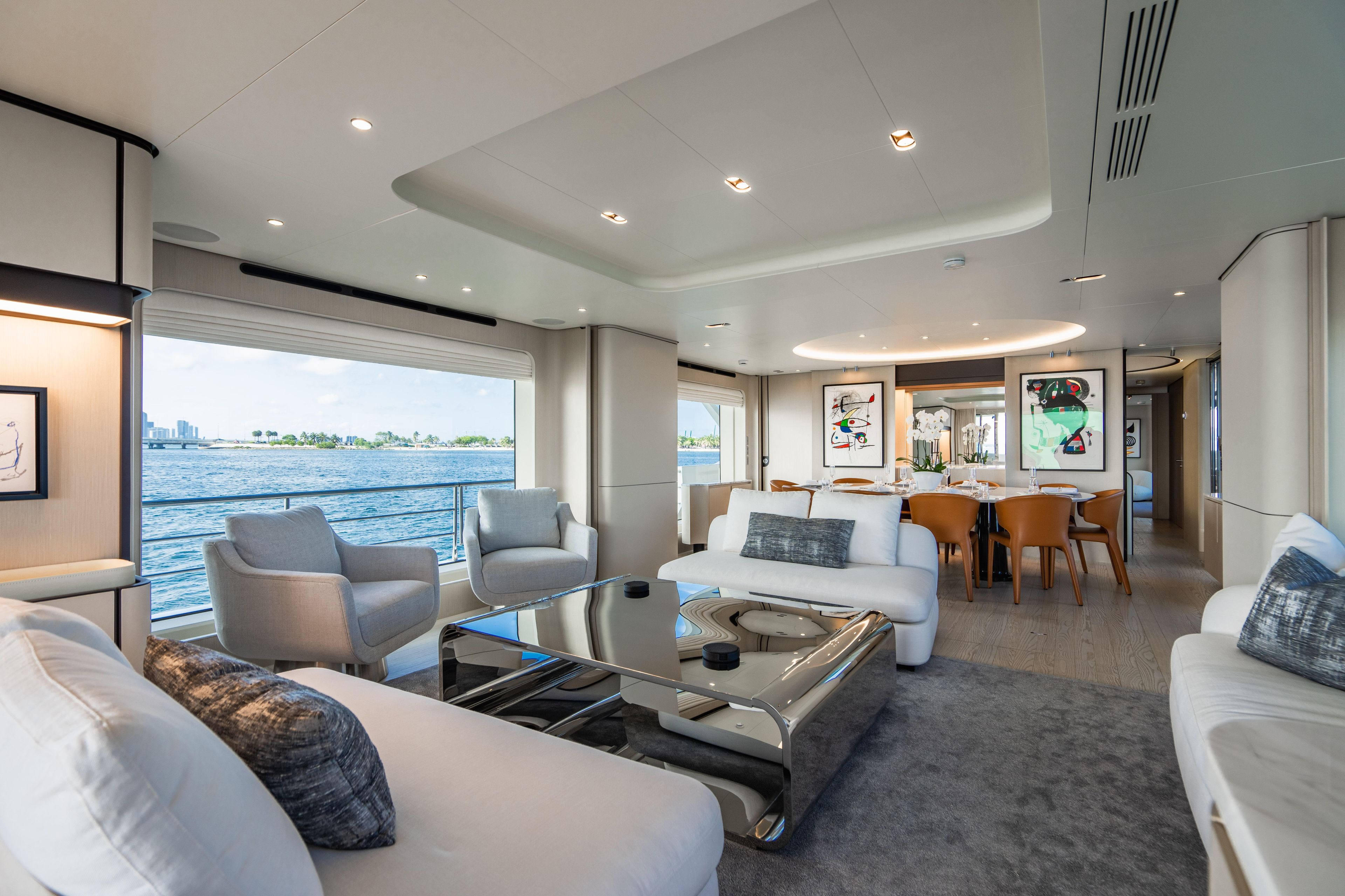 Luxurious 2023 Azimut yacht interior with modern decor, spacious seating, and ocean view.