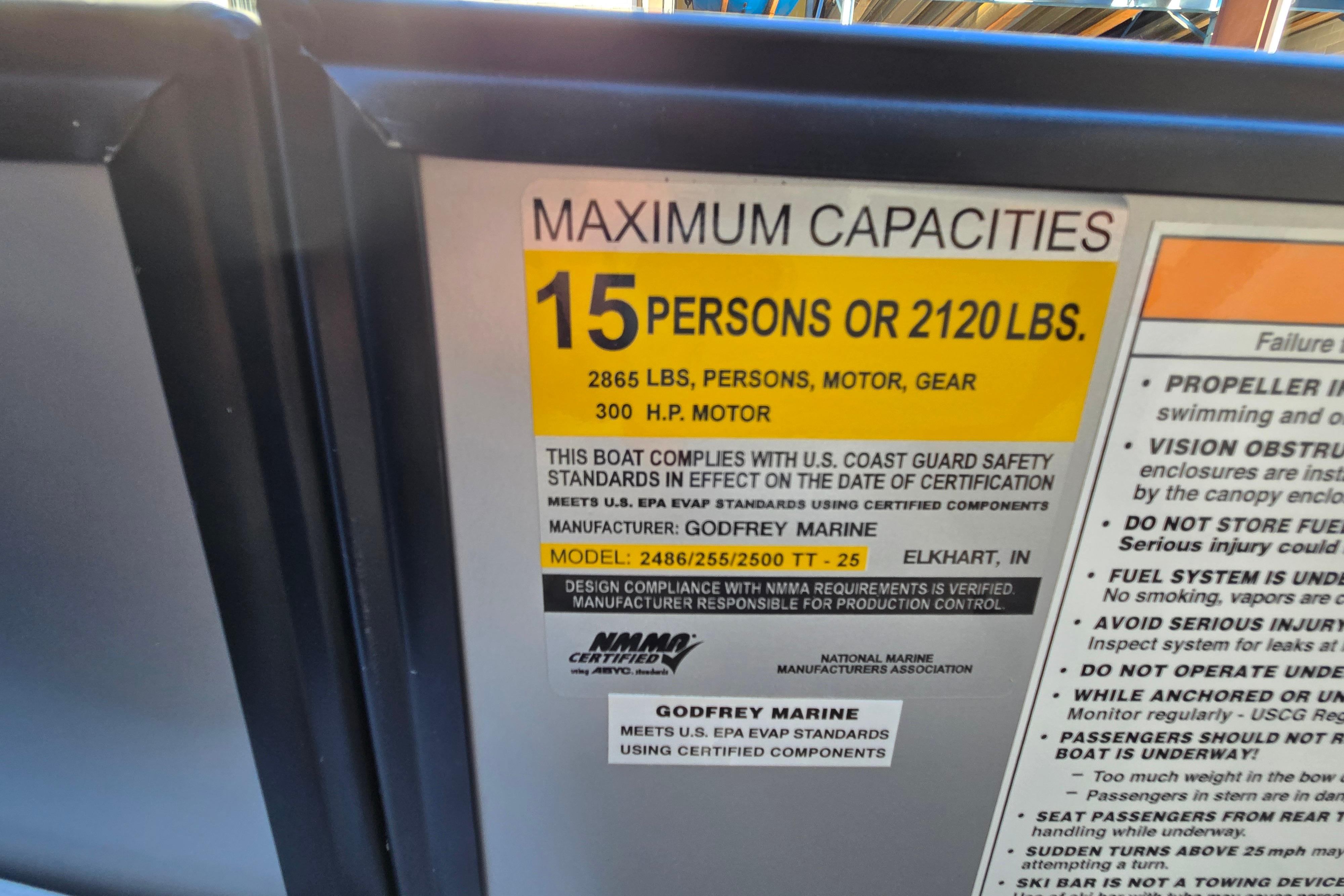 Capacity label on 2024 Godfrey Sweetwater 2486 SB boat, max 15 persons or 2120 lbs.