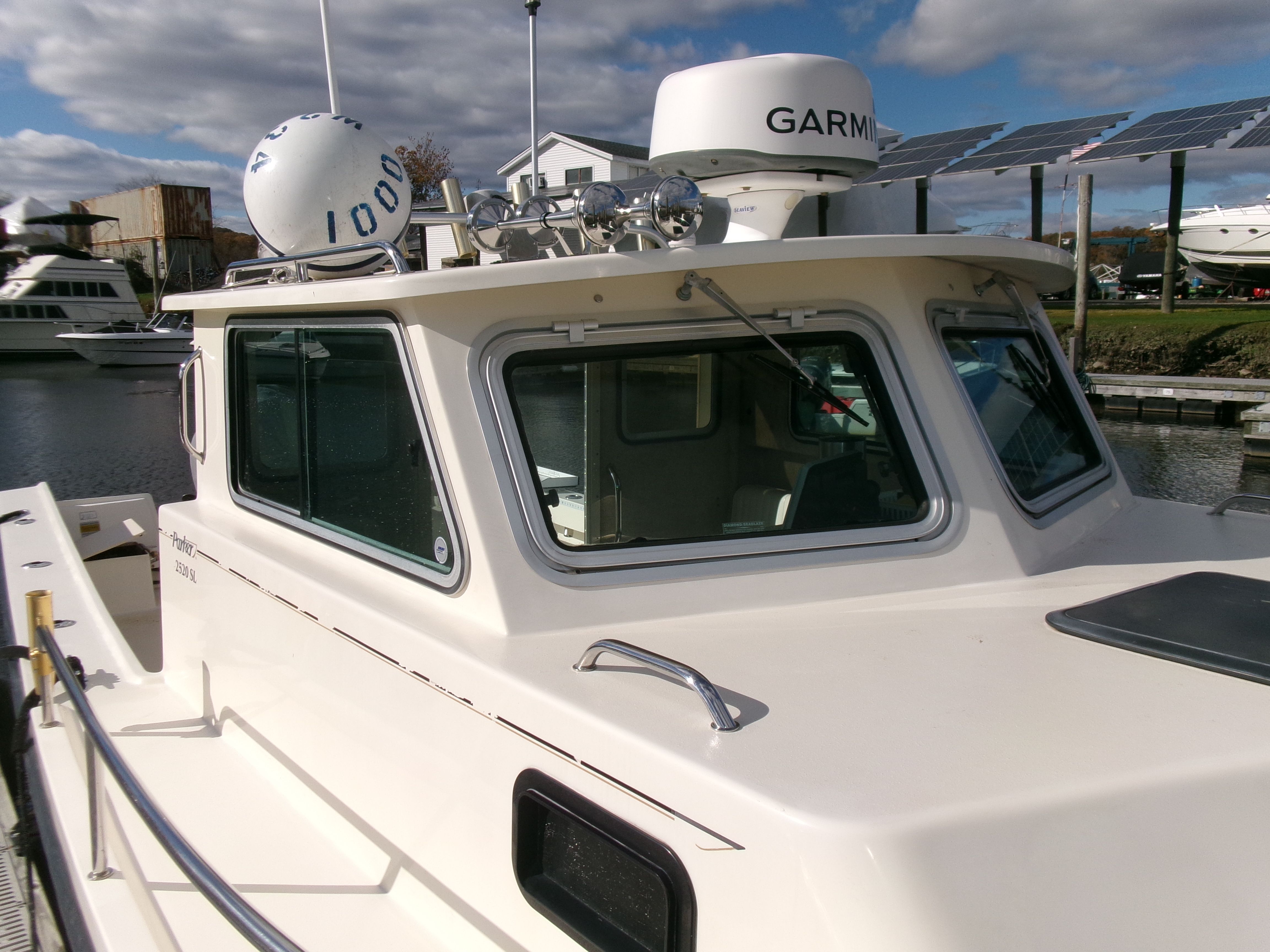 A 2007 Parker 2520 XL Sport Cabin boat docked in a marina. It features an enclosed cabin.