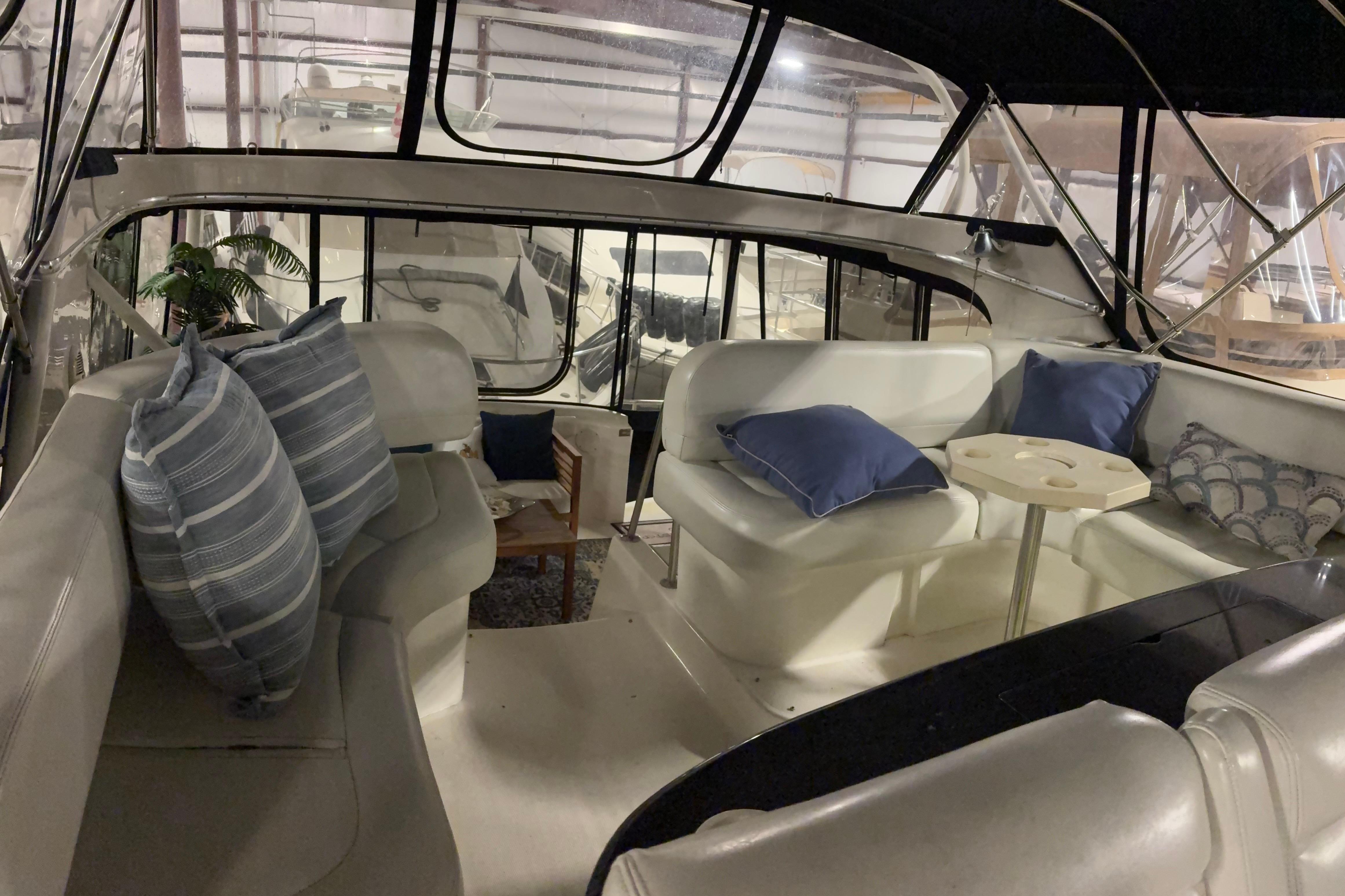 Interior of 2003 Silverton 43 Motor Yacht with cozy seating and decorative pillows.