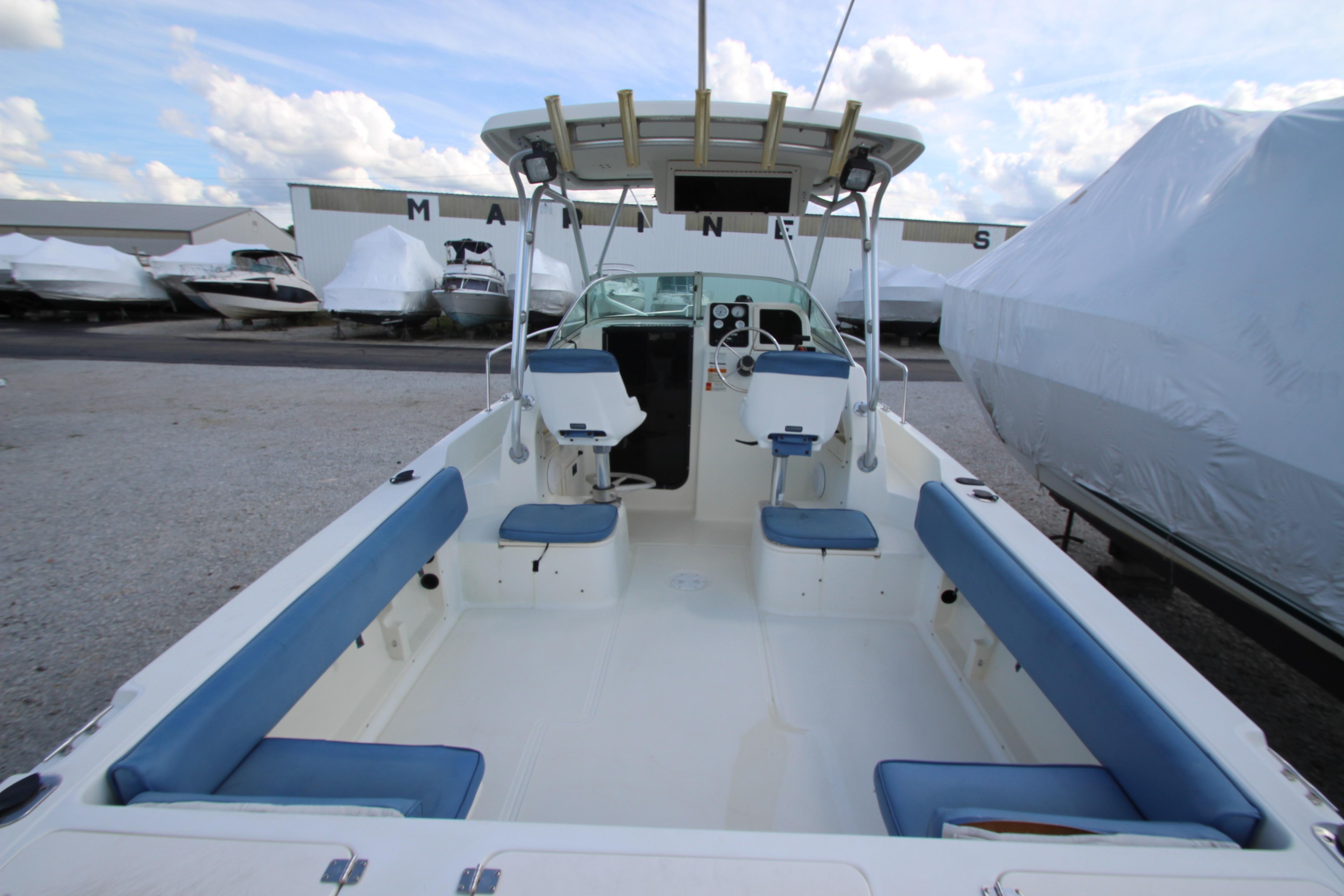 2002 Hydra-Sports 230 WA boat interior with blue seating, docked at a marina.