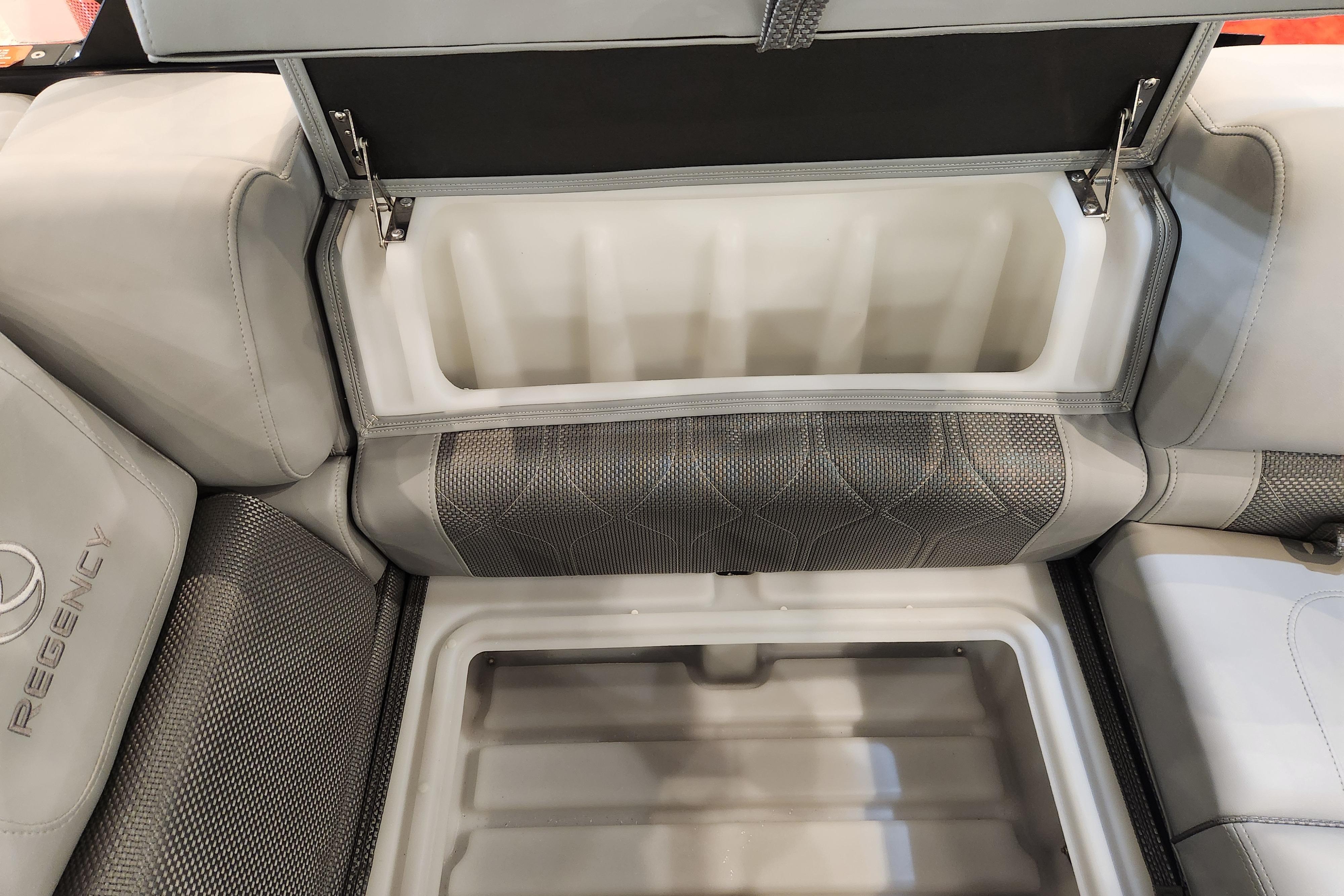 Open storage compartment in 2025 Regency 250 LE3 boat with cushioned seating.