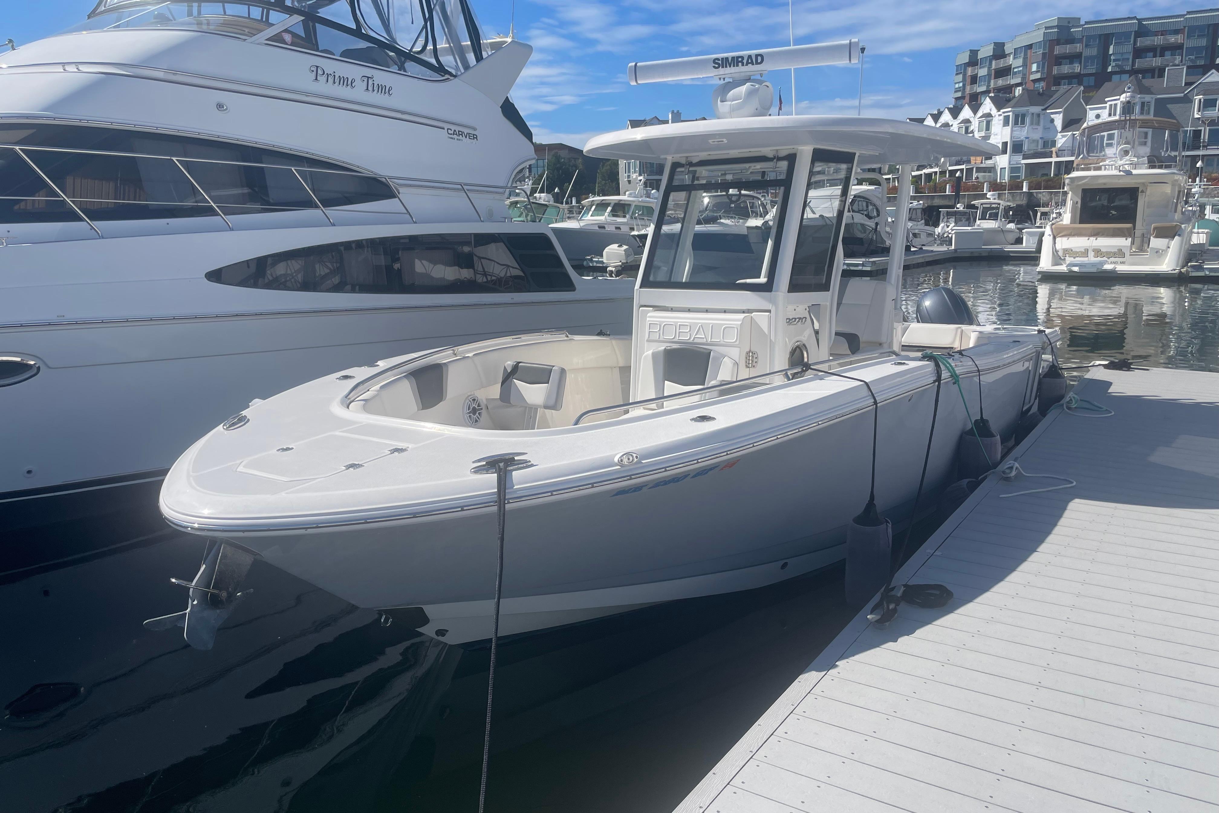 2023 Robalo R270 Center Console boat docked at a marina.