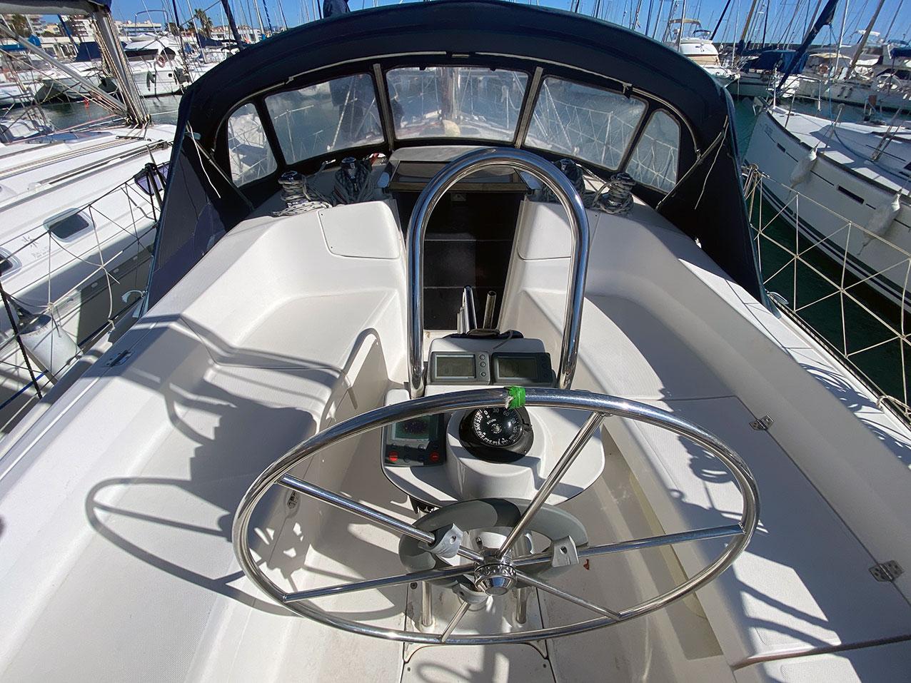 2003 Hunter 356 sailboat cockpit with steering wheel and navigation instruments.