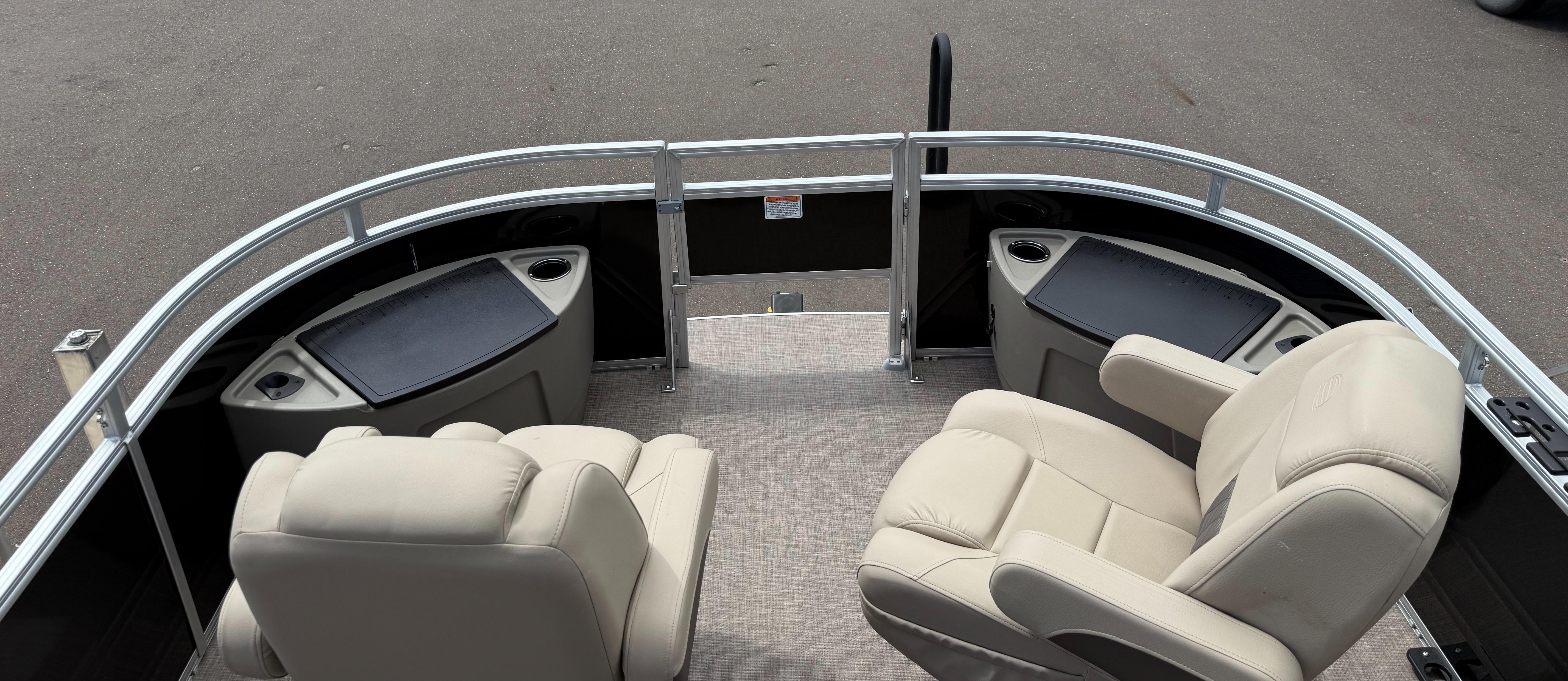2024 Sun Tracker Sportfish 24 XP3 boat interior with beige seating and storage compartments.