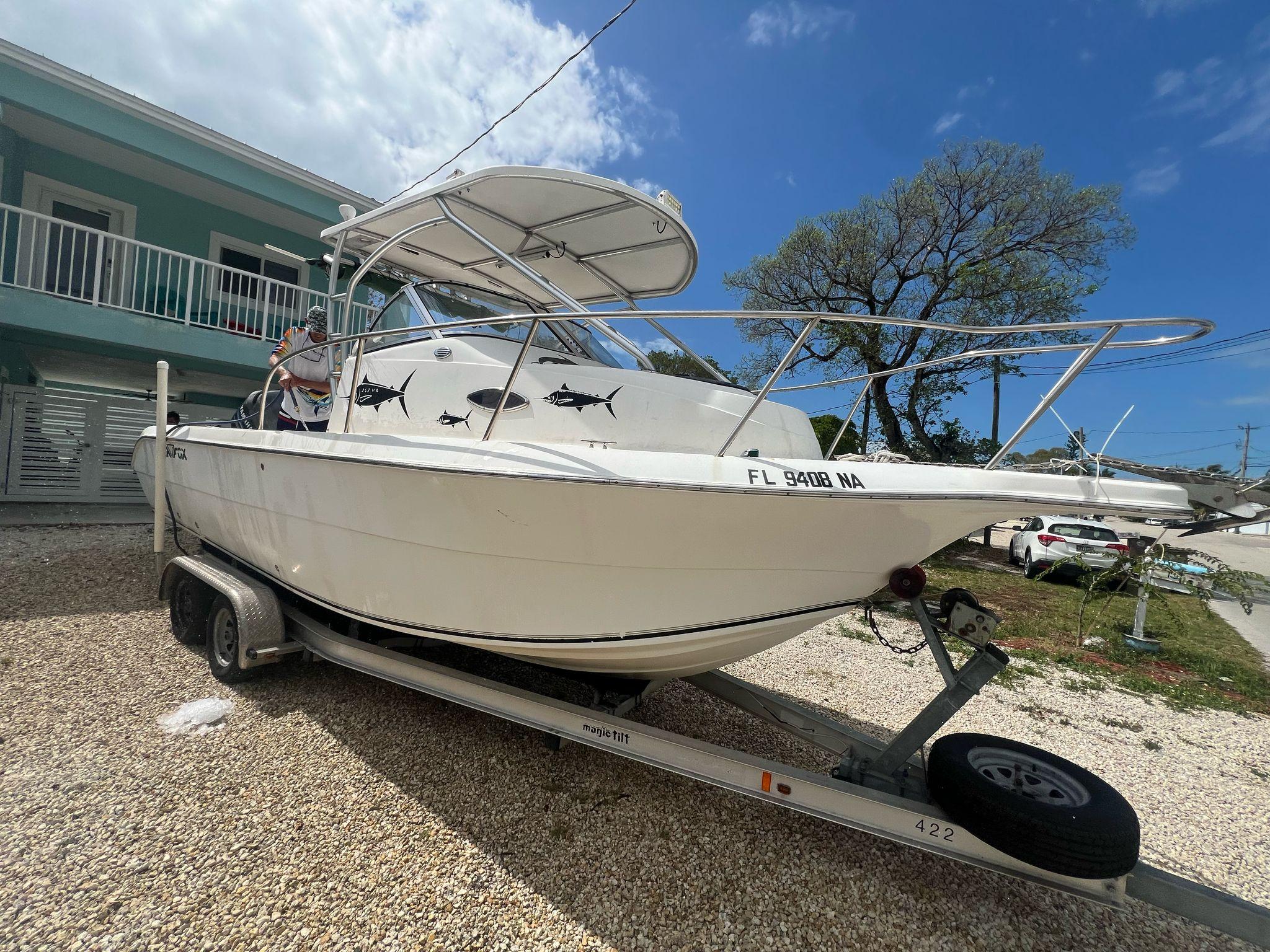2006 Sea Fox 257 Walk Around boat on trailer, parked outdoors under a clear sky.