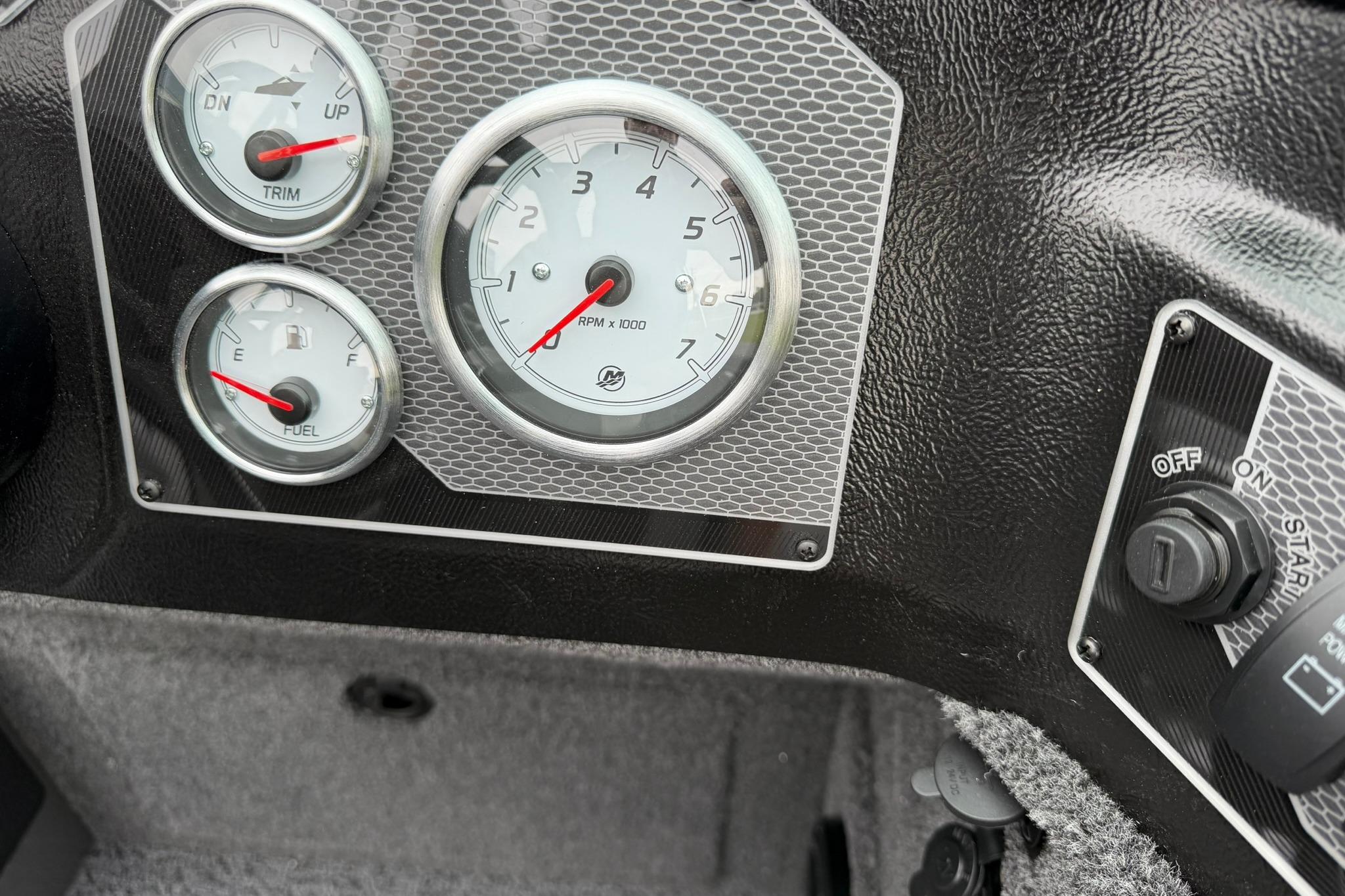 Dashboard of 2027 Lund 2075 Impact XS boat with gauges and ignition switch.