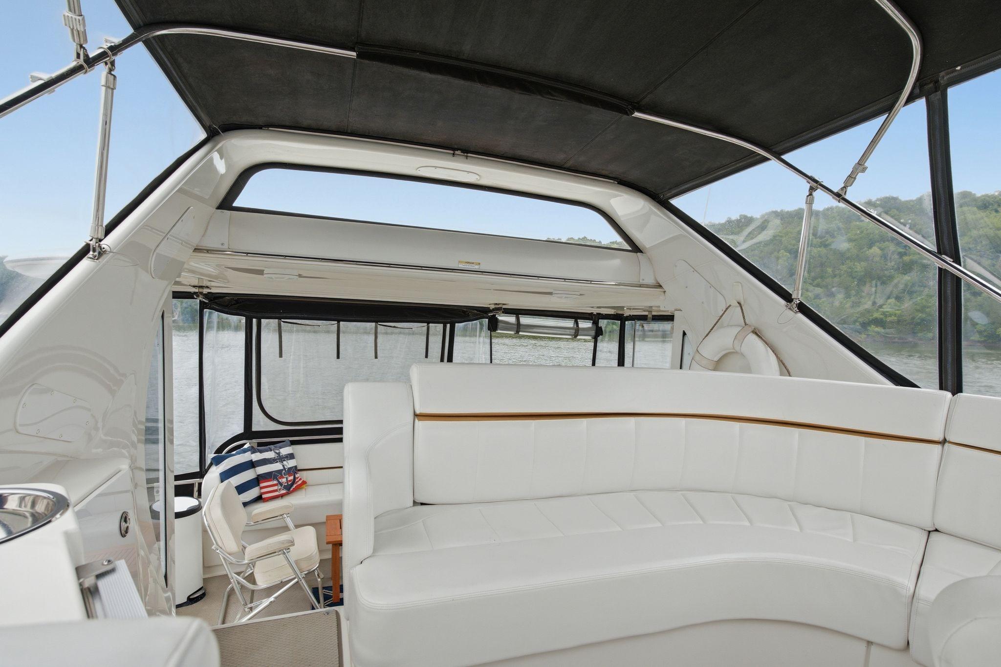 2005 Carver 39 Motor Yacht interior with white seating and scenic water view.