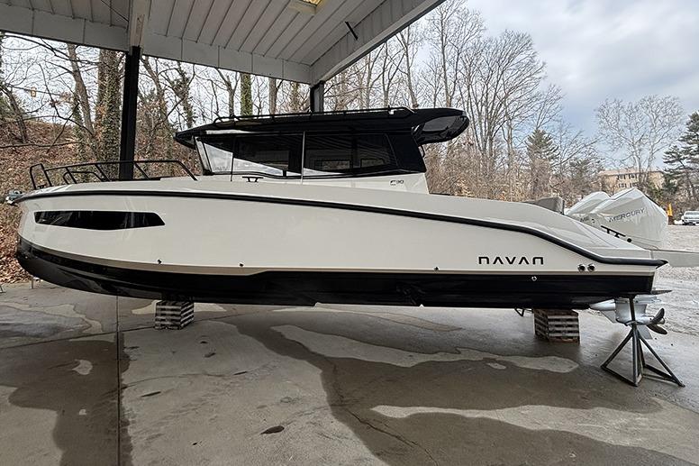 2026 Navan C30 boat displayed on stands under a covered area.