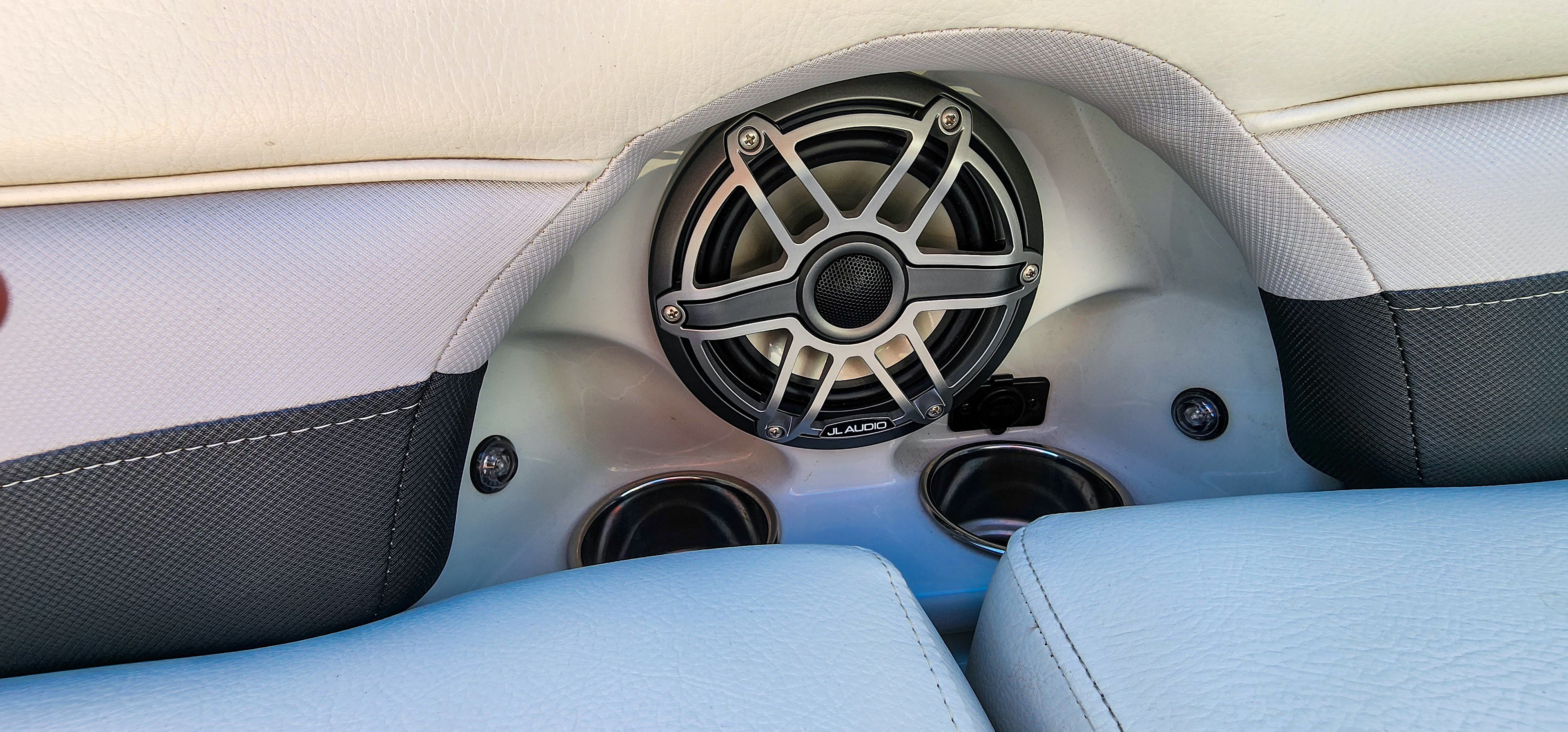 Close-up of a speaker and two cup holders in a boat.
