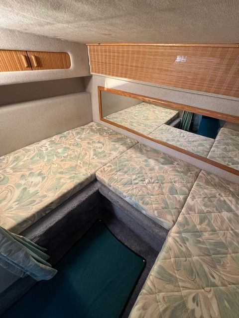 Interior of the 1992 Sea Ray 290 Sundancer with cushioned seating and a mirror.