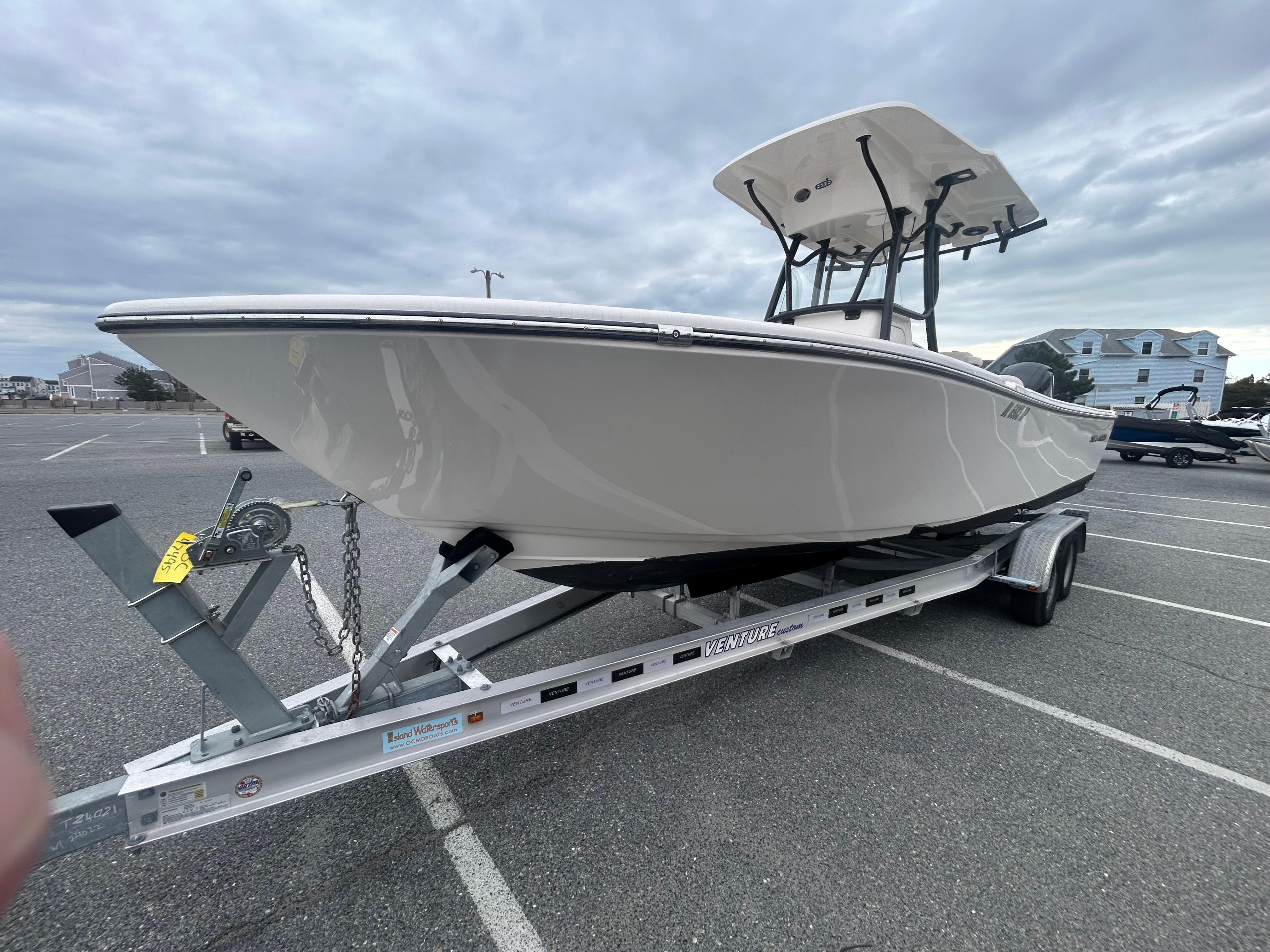 2024 Sea Born LX24 LE boat on trailer in parking lot.