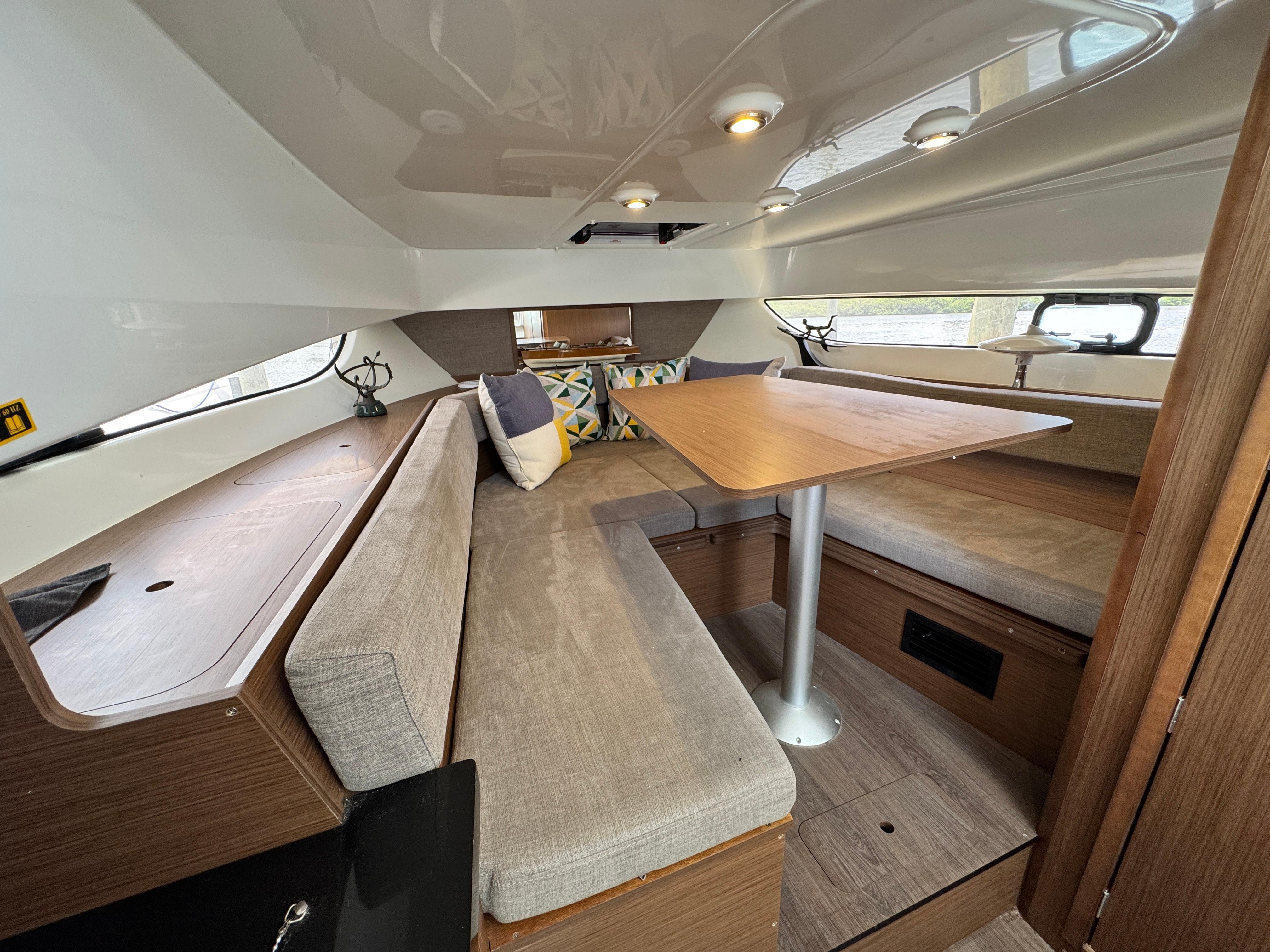 2022 Beneteau Flyer 9 SUNdeck cabin interior with seating and table.