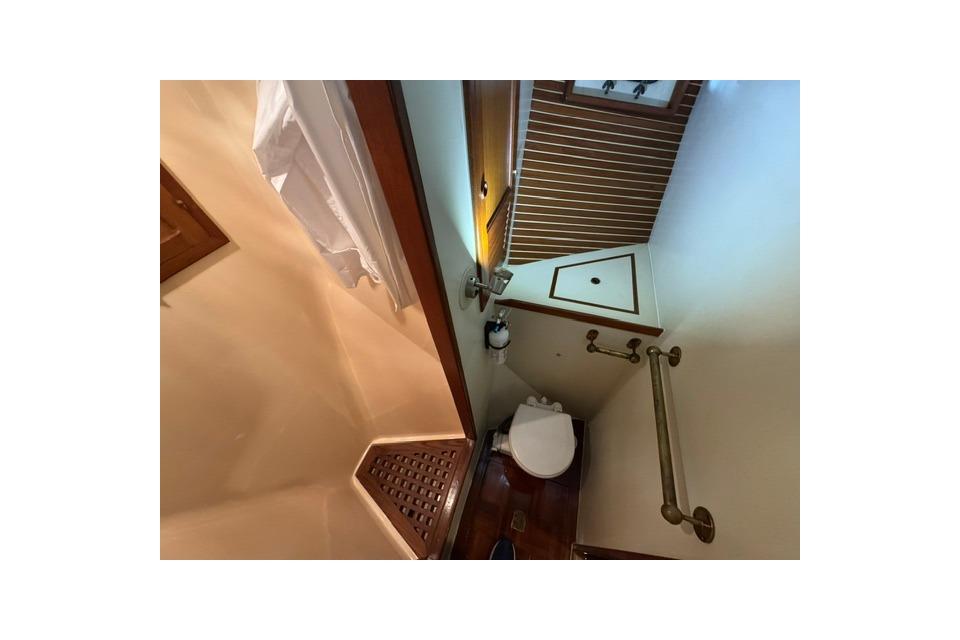 Bathroom interior of 1986 Kadey-Krogen 42 yacht, featuring wooden accents and compact design.