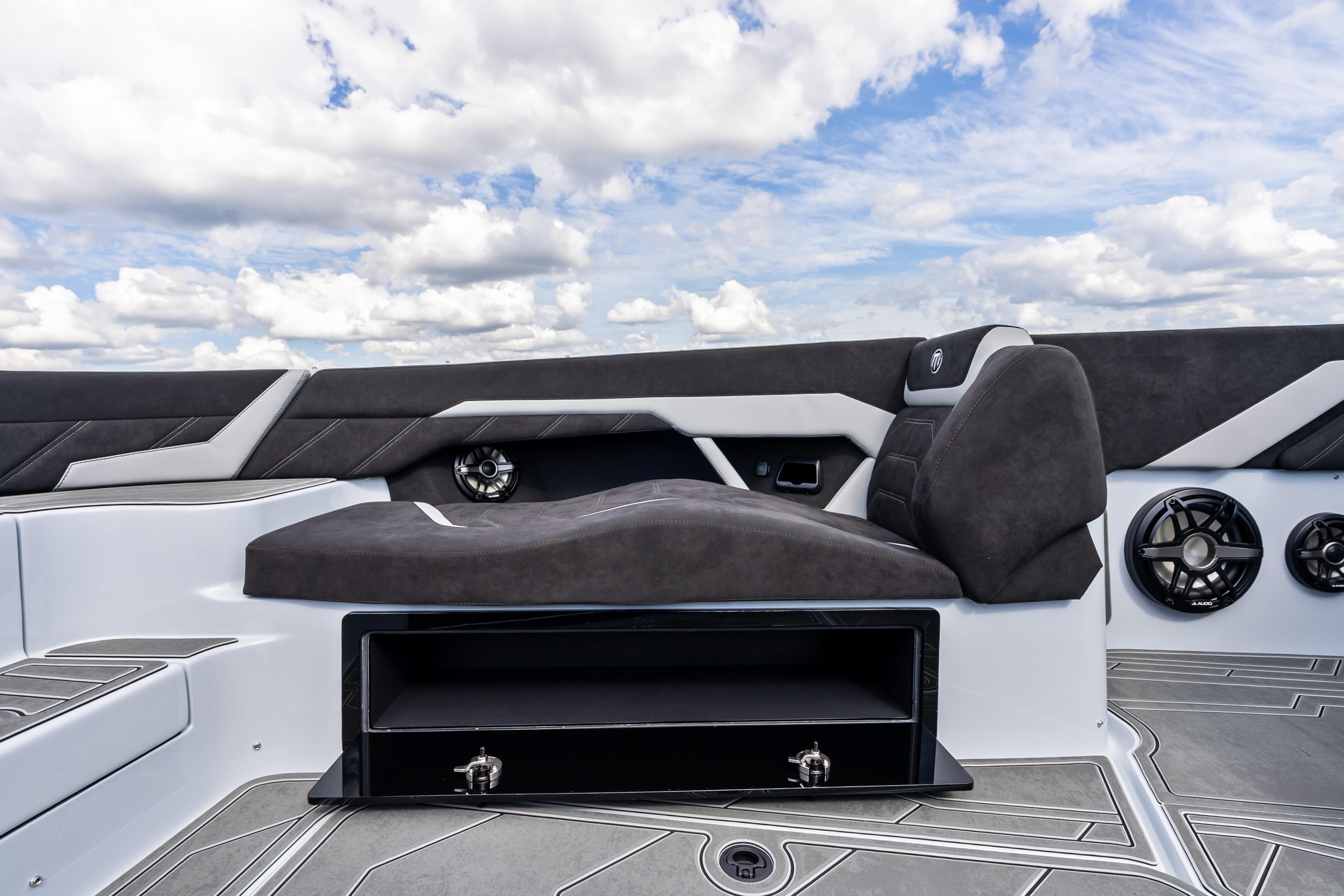 Luxurious seating on 2027 Mystic Powerboats M4200, featuring sleek design and integrated speakers.