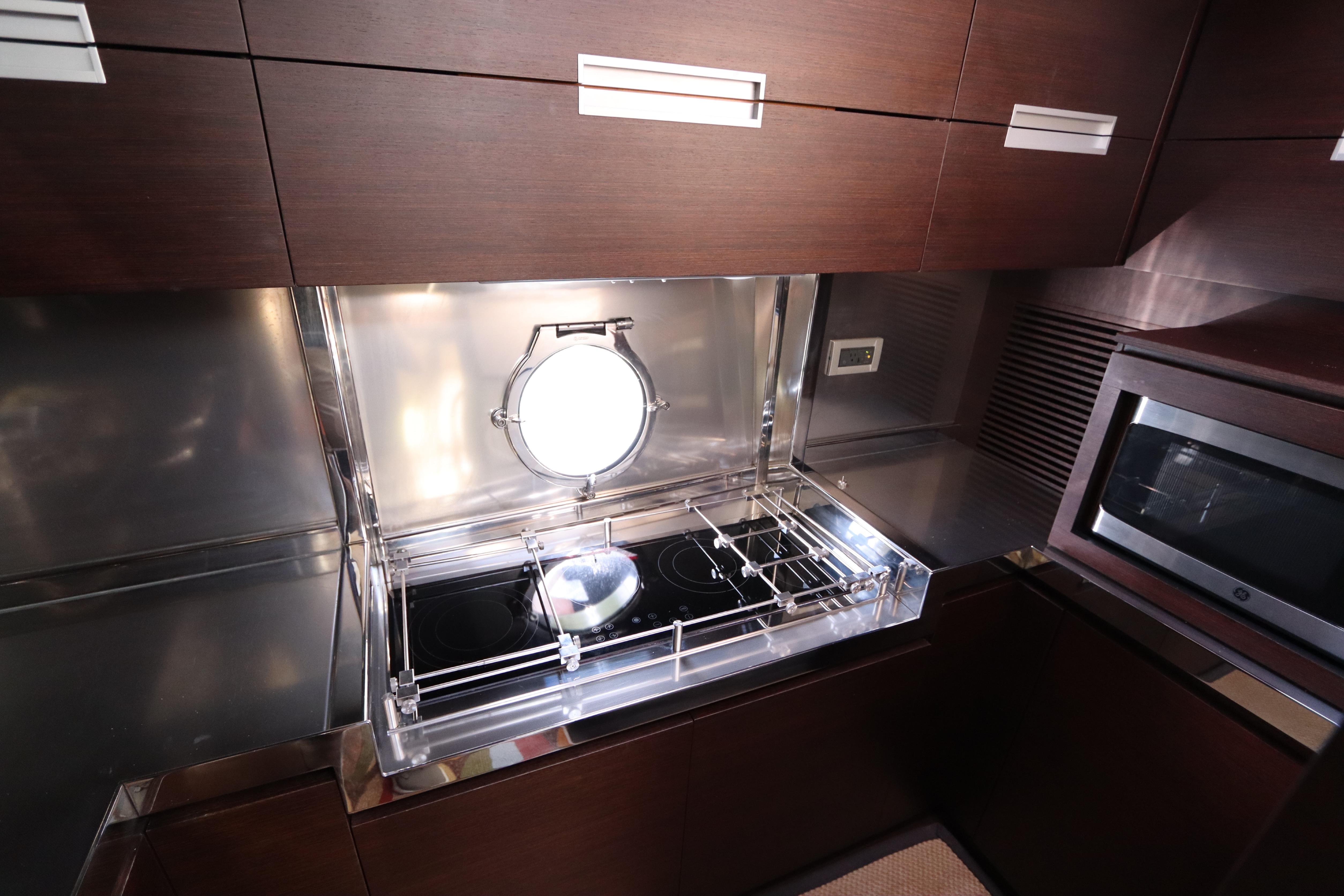 Luxurious kitchen in 2007 Azimut 62S yacht with modern appliances and sleek design.