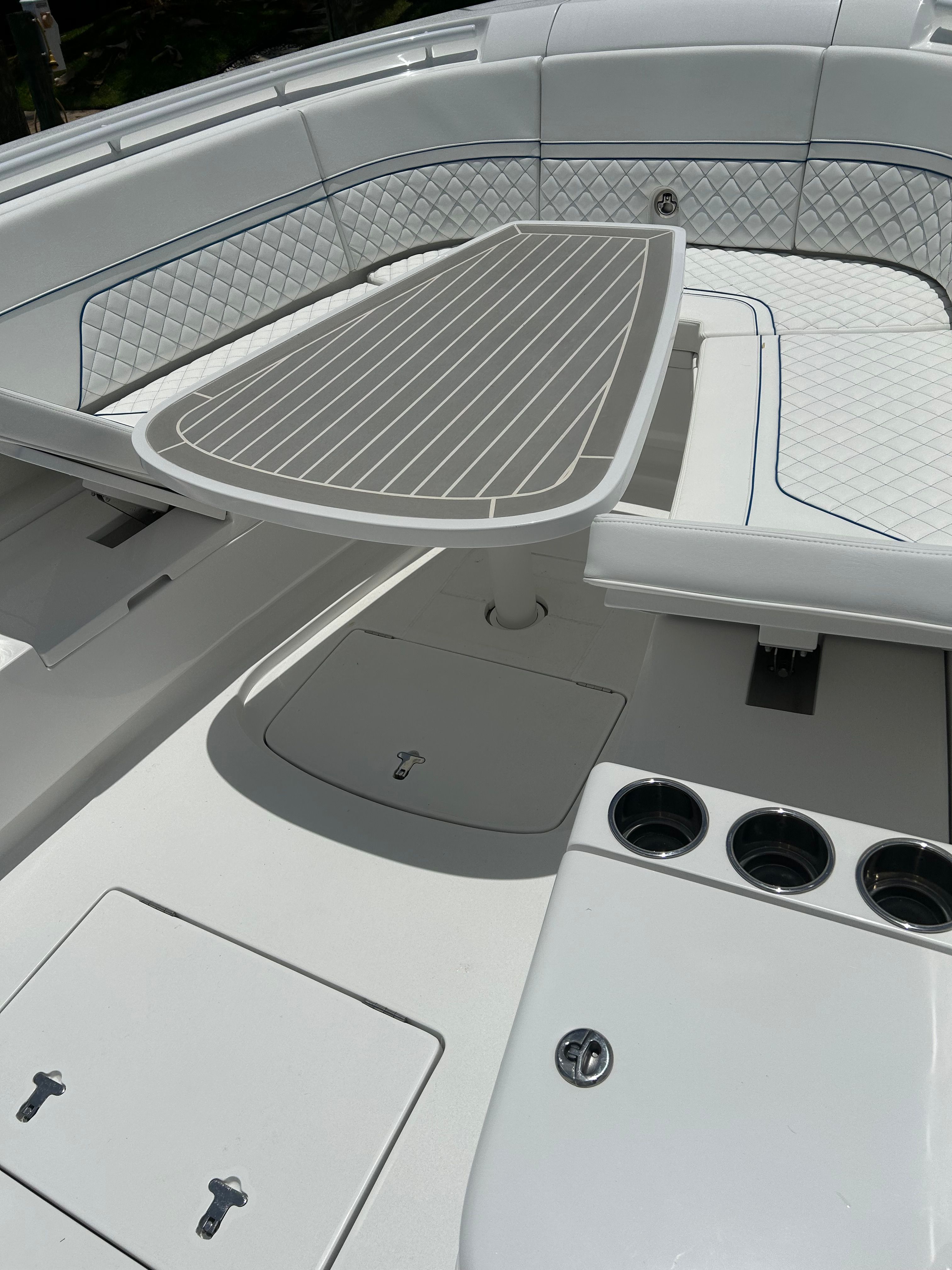 Intrepid 375 Nomad SE 2025, luxurious boat seating area with table.