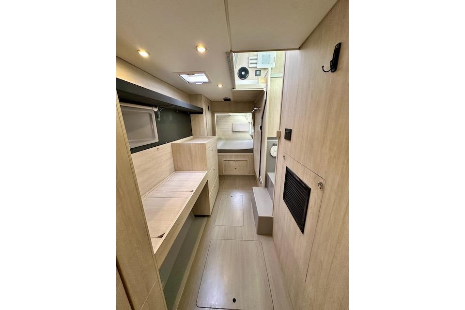 Interior of 2017 Leopard 40 catamaran, featuring modern wood finish and compact design.