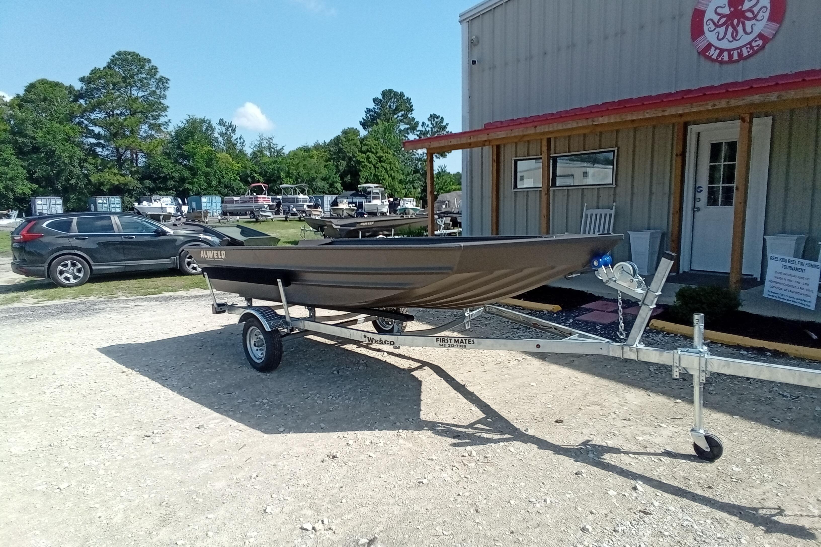 2026 Alweld 1448VV Vee Bottom boat on trailer outside a building.