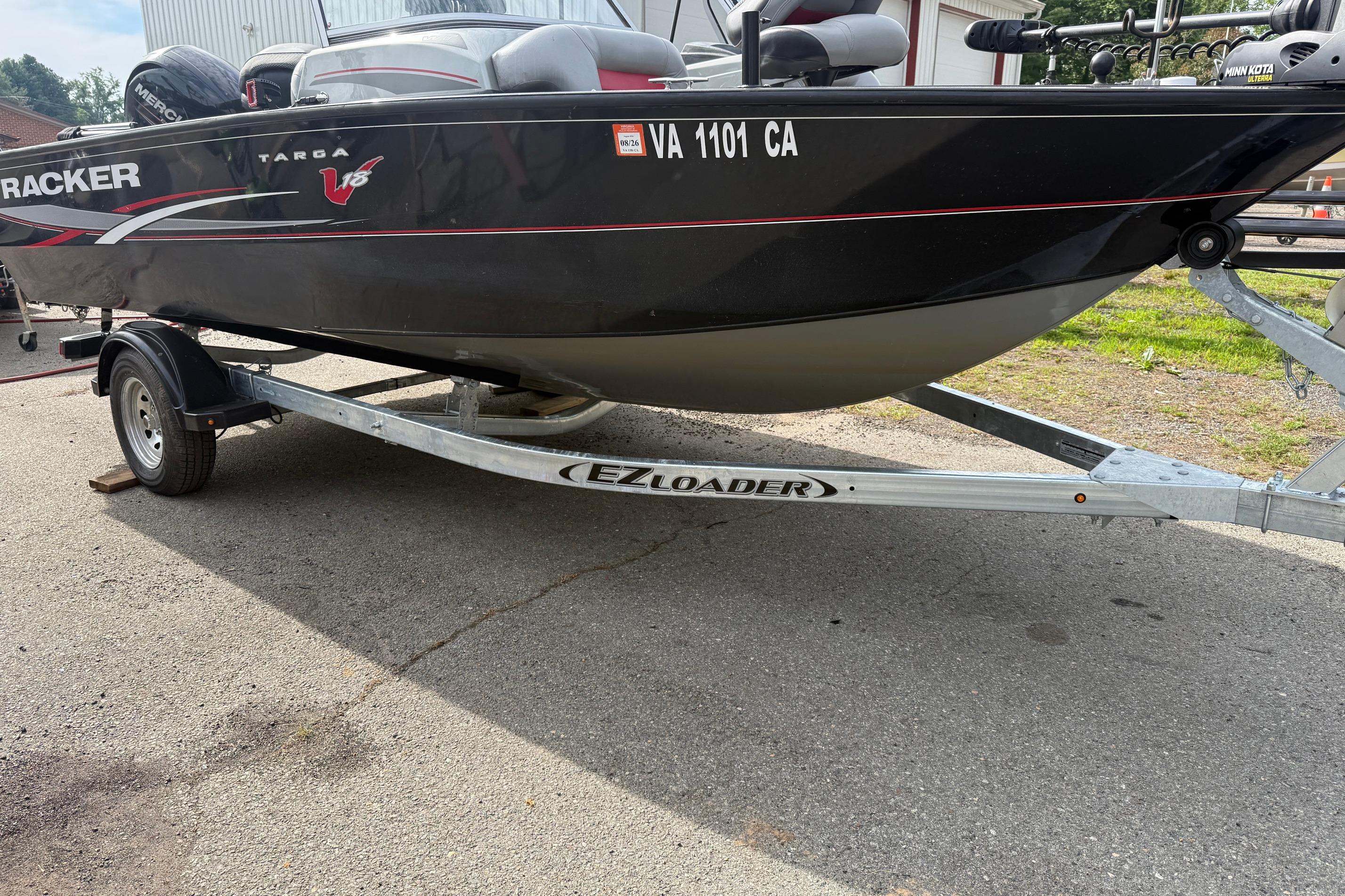 2016 Tracker Targa V-18 WT boat on EZ Loader trailer, parked outdoors.