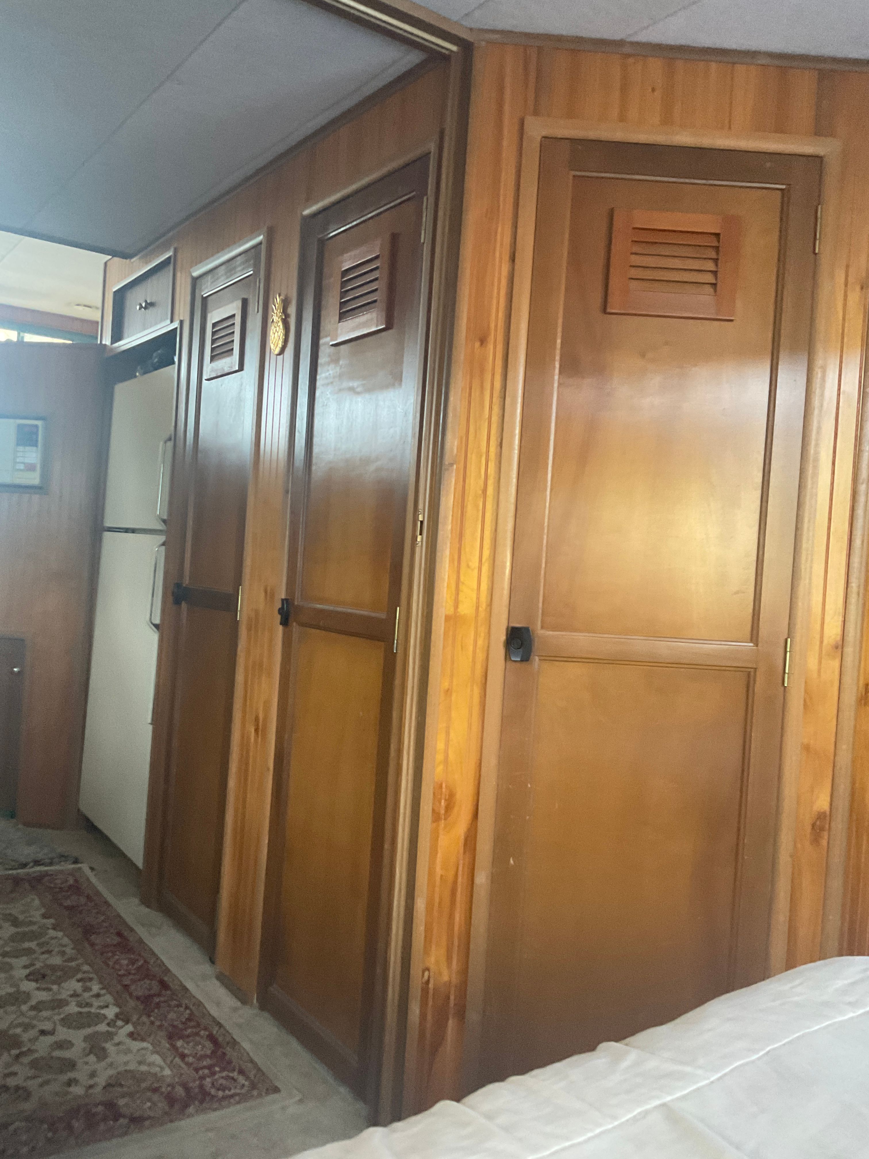 Interior of a 1996 Gibson 44 Standard with wooden doors and carpeted floor.