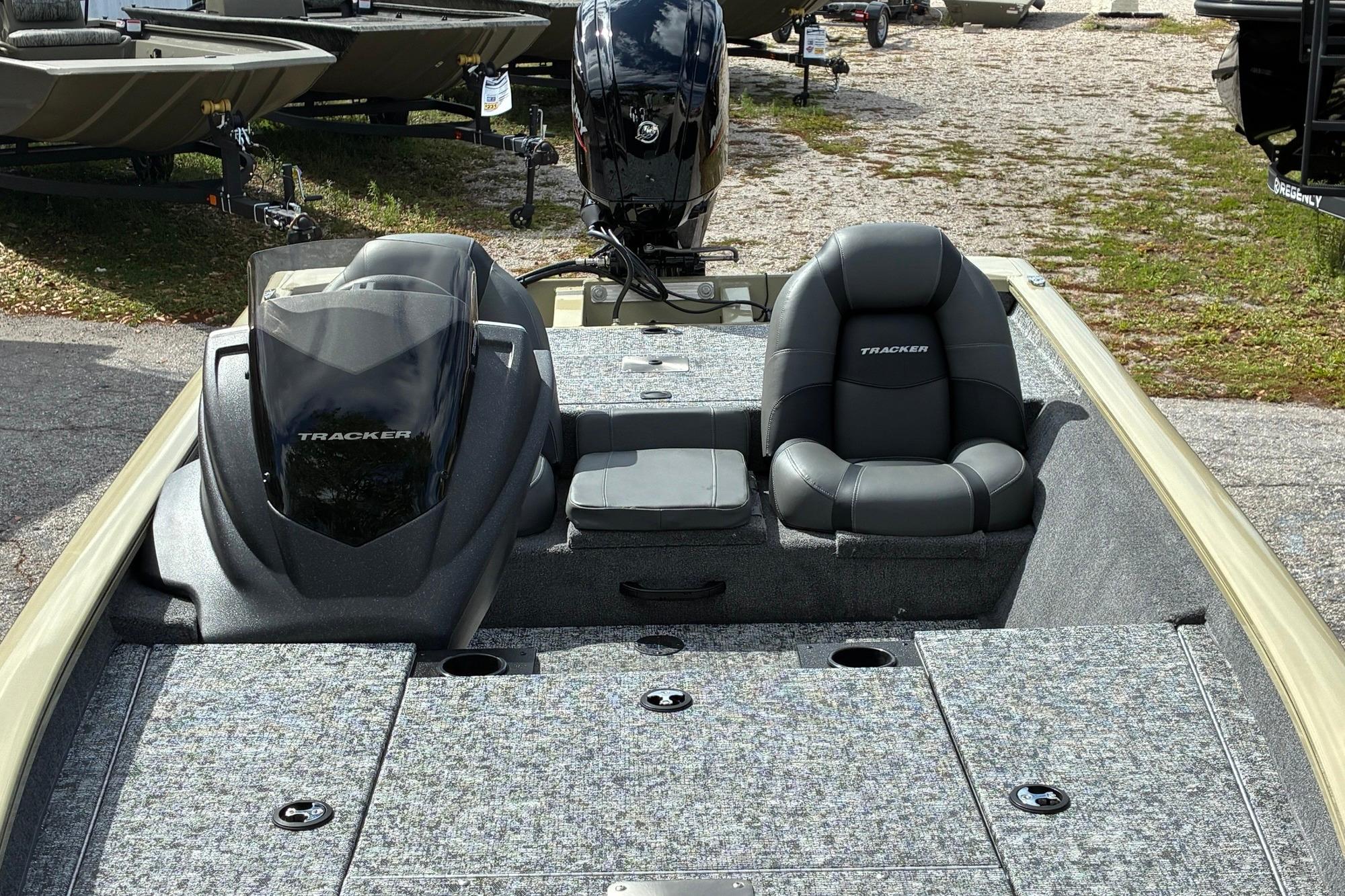 2026 Tracker Pro Team 175 boat interior with seating and console, parked outdoors.