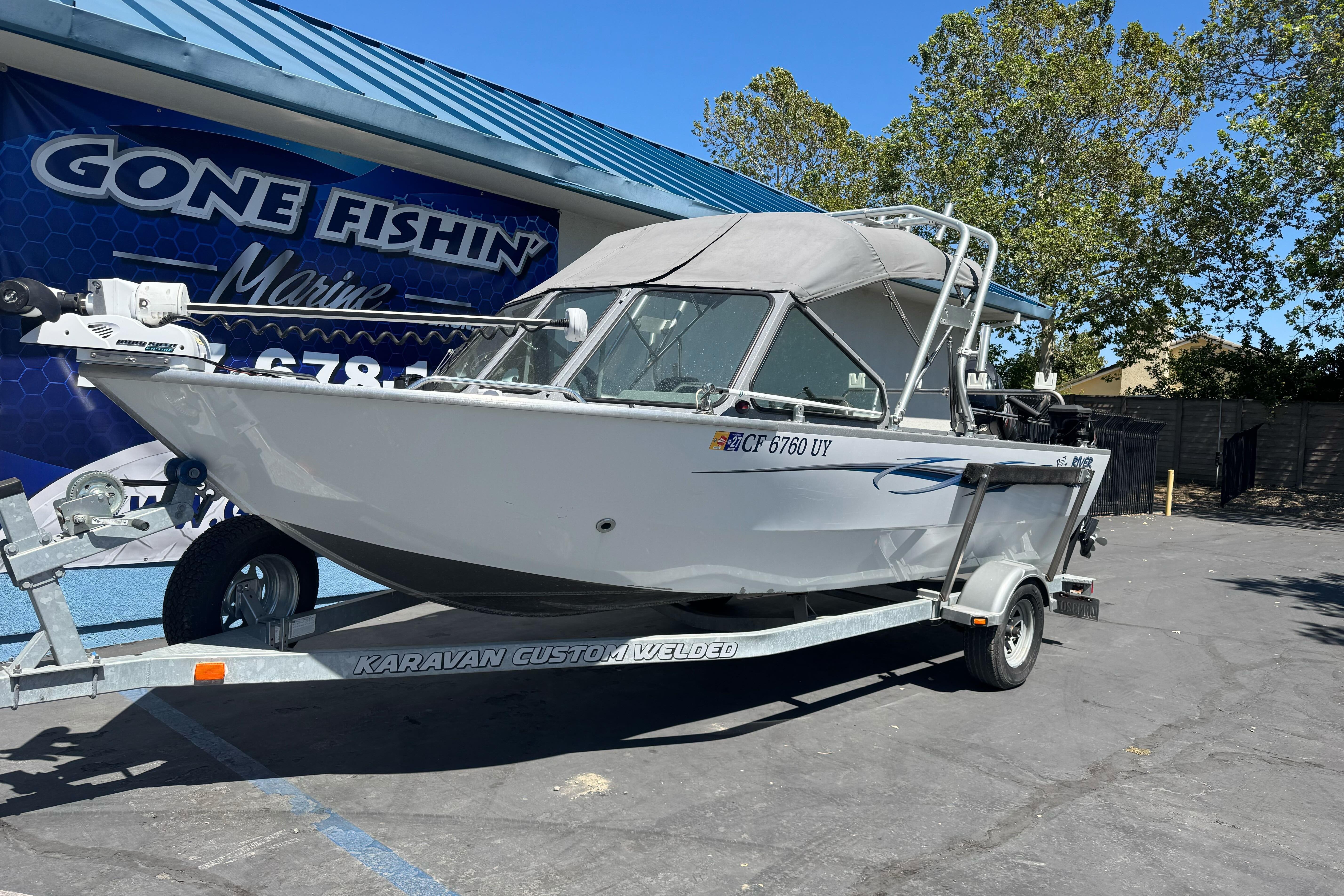 2014 River Hawk 19 GB boat on trailer at Gone Fishin' Marine dealership.