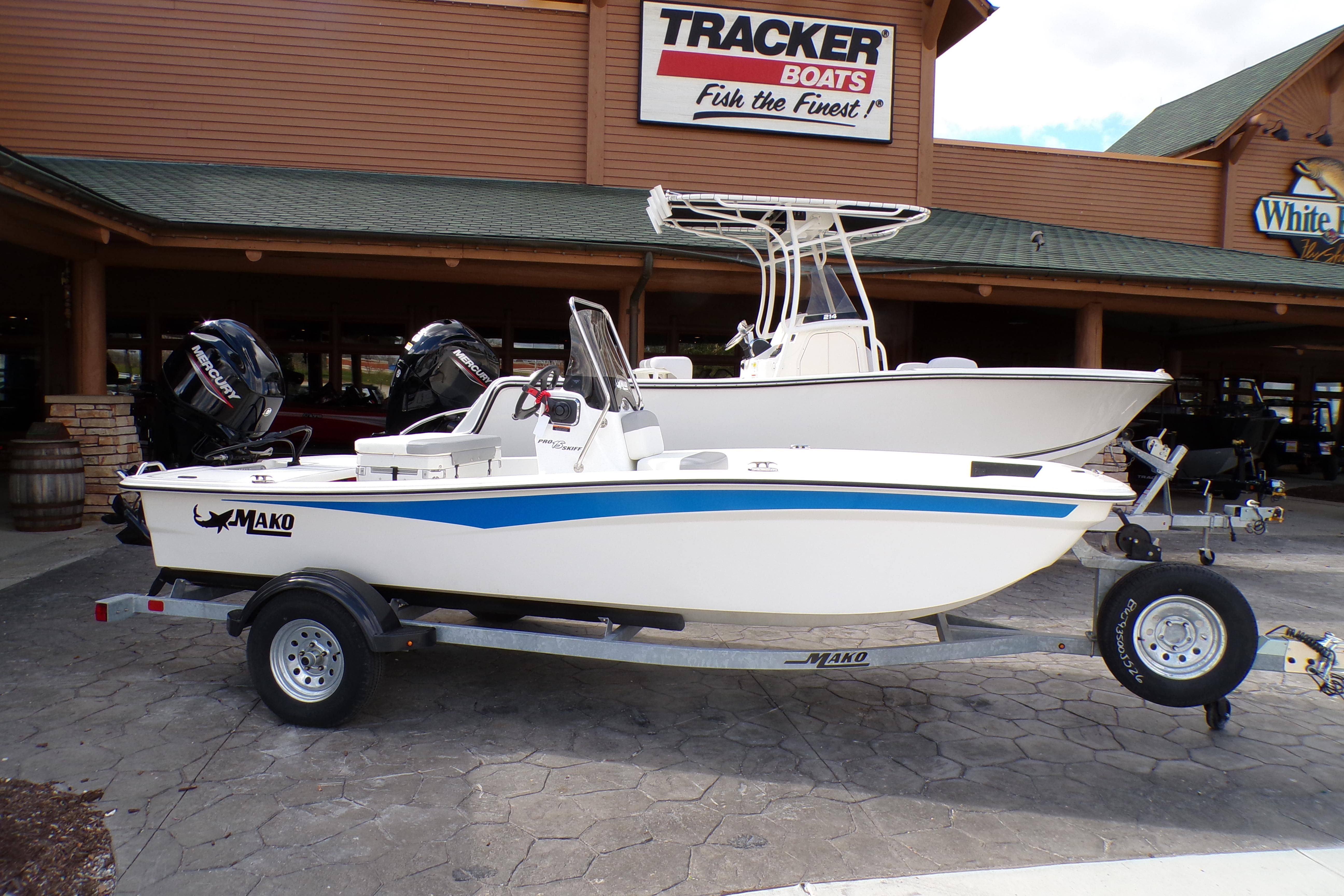 2026 Mako Pro Skiff 15 CC boat on trailer, displayed outside Tracker Boats dealership.