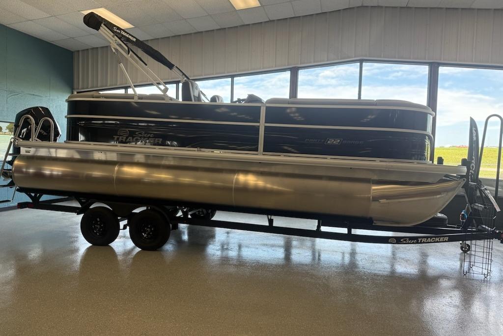 2026 Sun Tracker Party Barge 22 XP3 pontoon boat displayed indoors on a trailer.