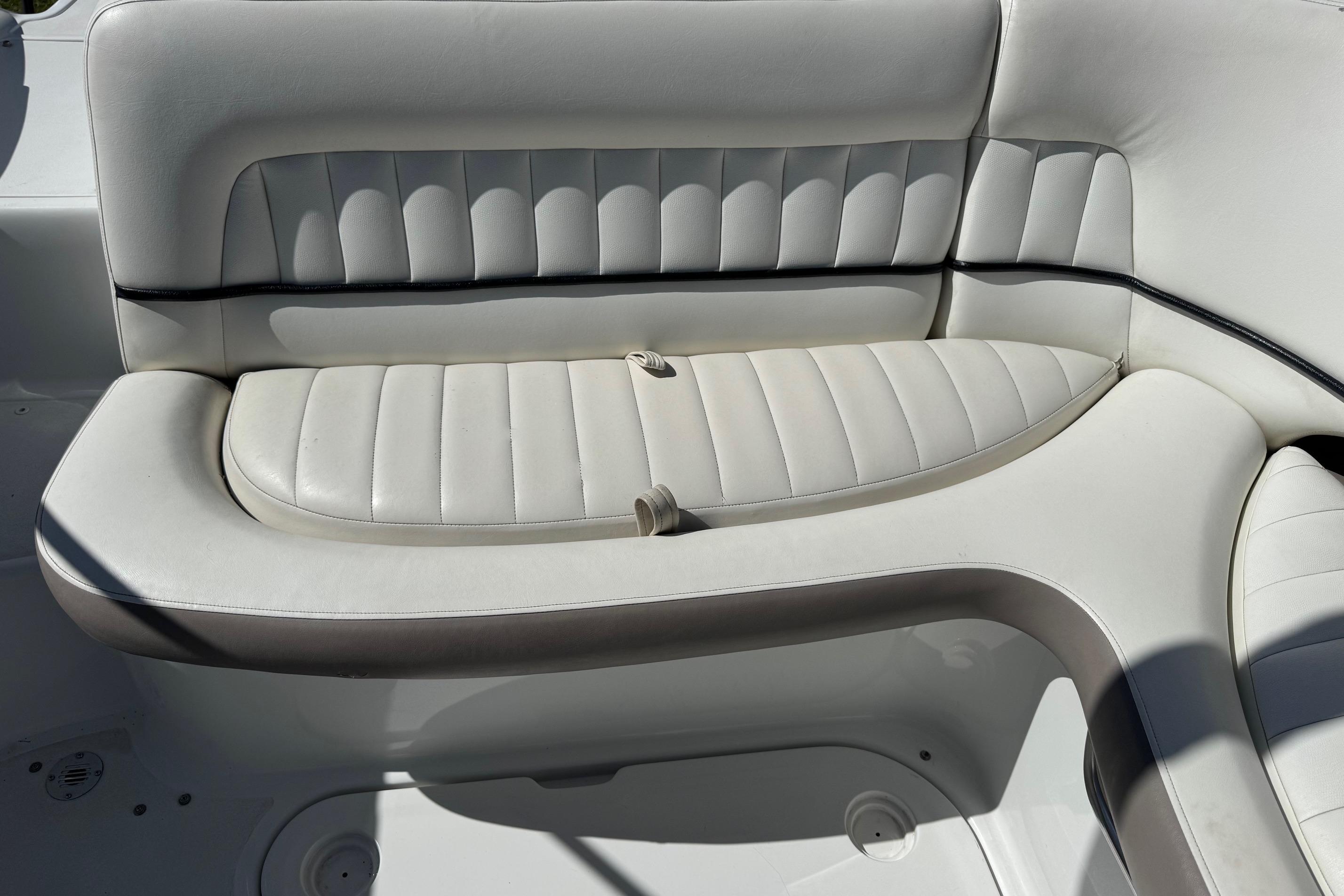 White leather seating on a 2005 Cobalt 240 boat, showcasing elegant design and comfort.