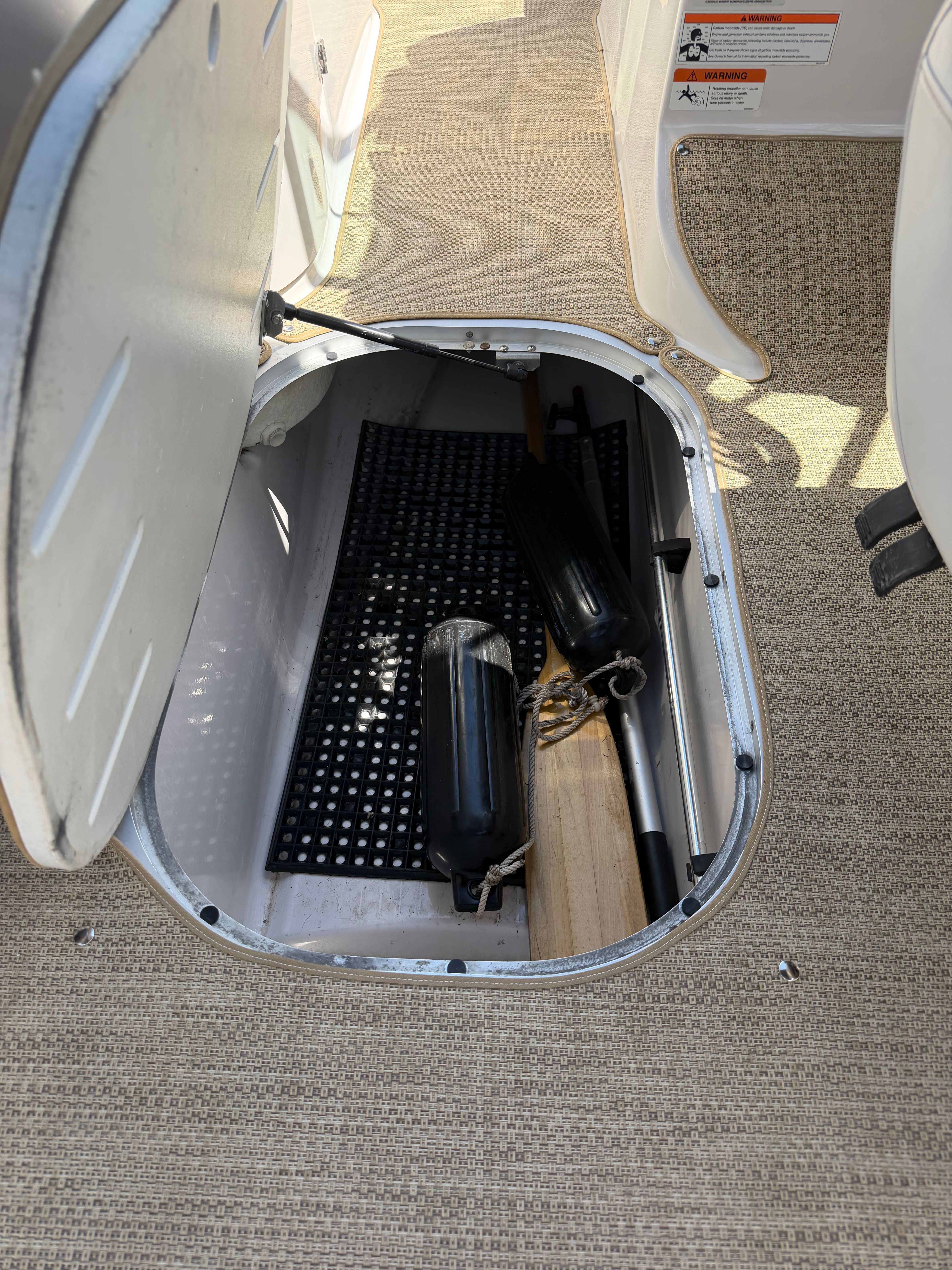 Floor storage compartment with fenders and a paddle.