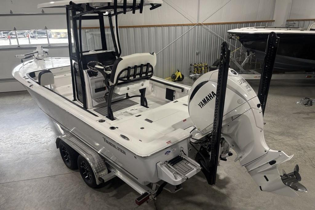 2026 Tidewater 2300 Carolina Bay boat with Yamaha engine in a garage.