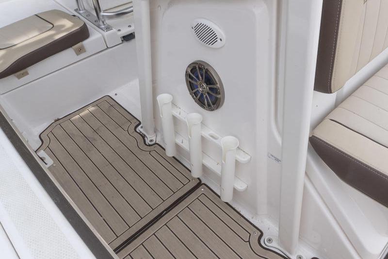 2023 Yamaha Boats 195 FSH Sport interior with rod holders and speaker.