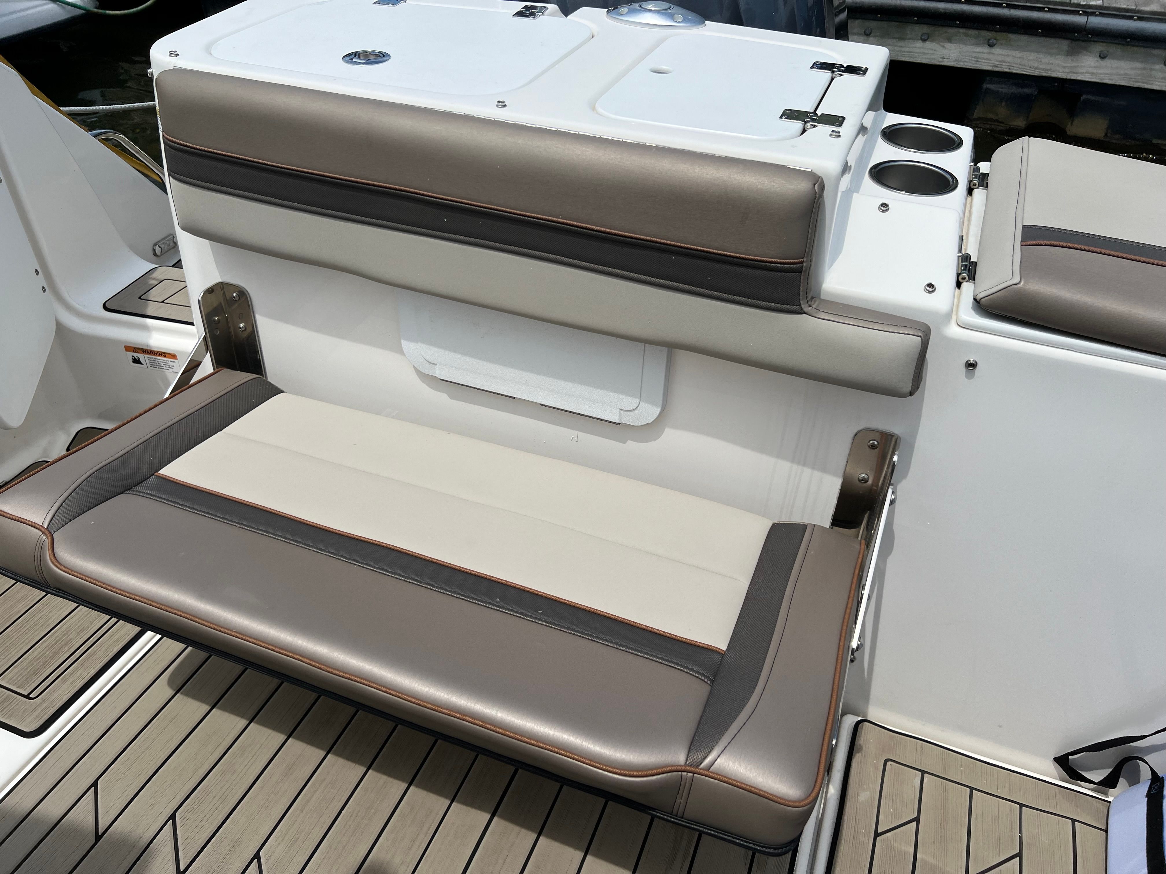 The 2022 Cutwater C-24 CW features a cushioned bench seat with brown and cream upholstery.