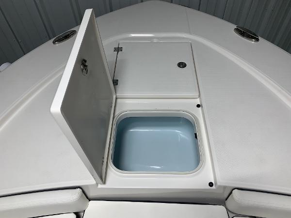2024 Robalo 246 Cayman boat with open storage compartment.