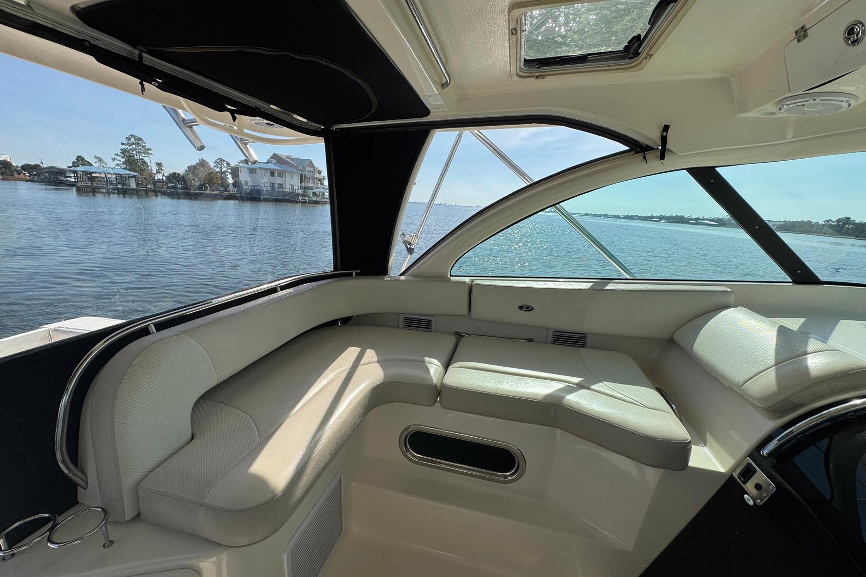 Interior view of 2011 Pursuit OS 375 Offshore boat with waterfront scenery.