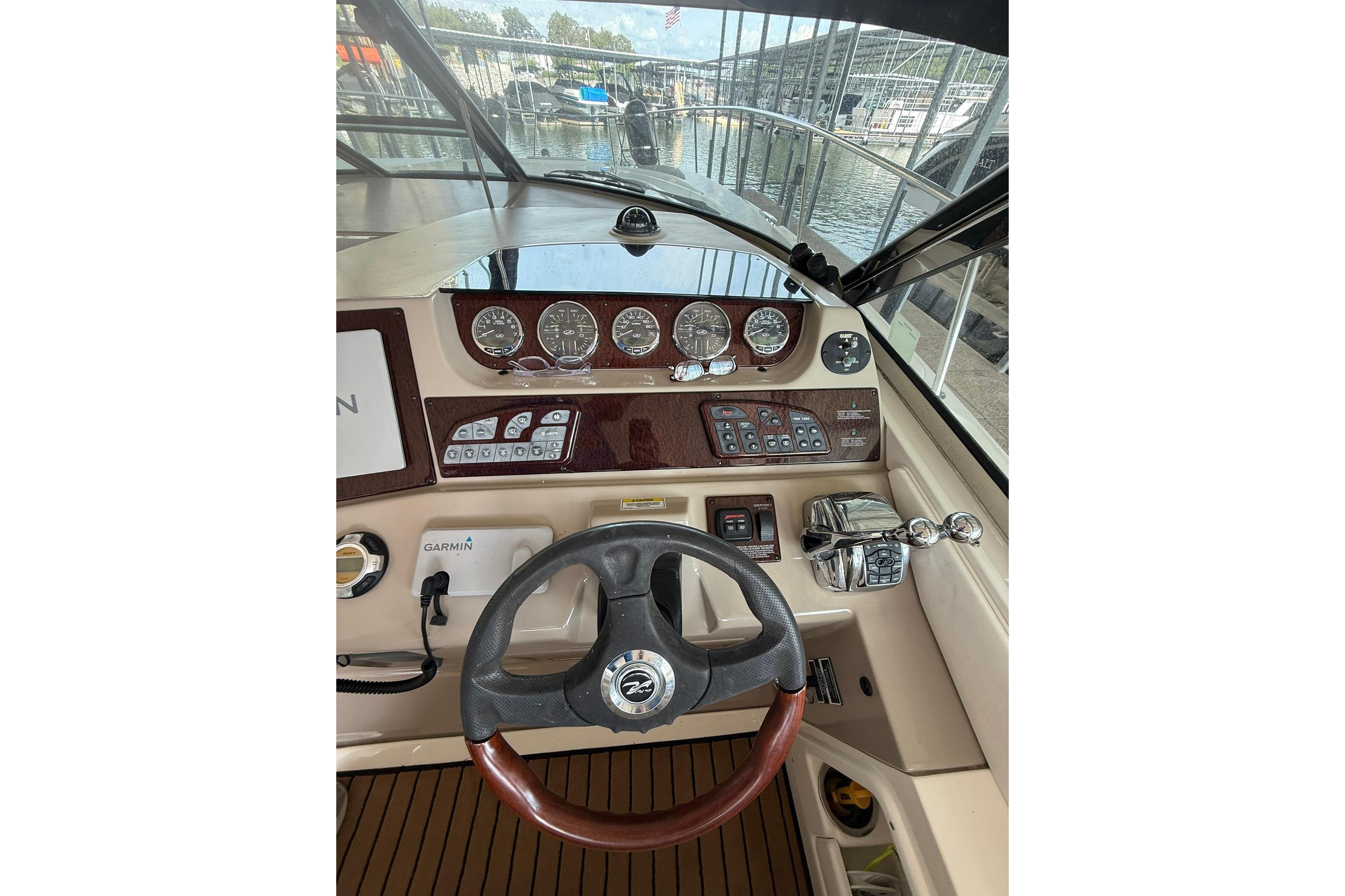 2009 Sea Ray 350 Sundancer helm with steering wheel, gauges, and controls.