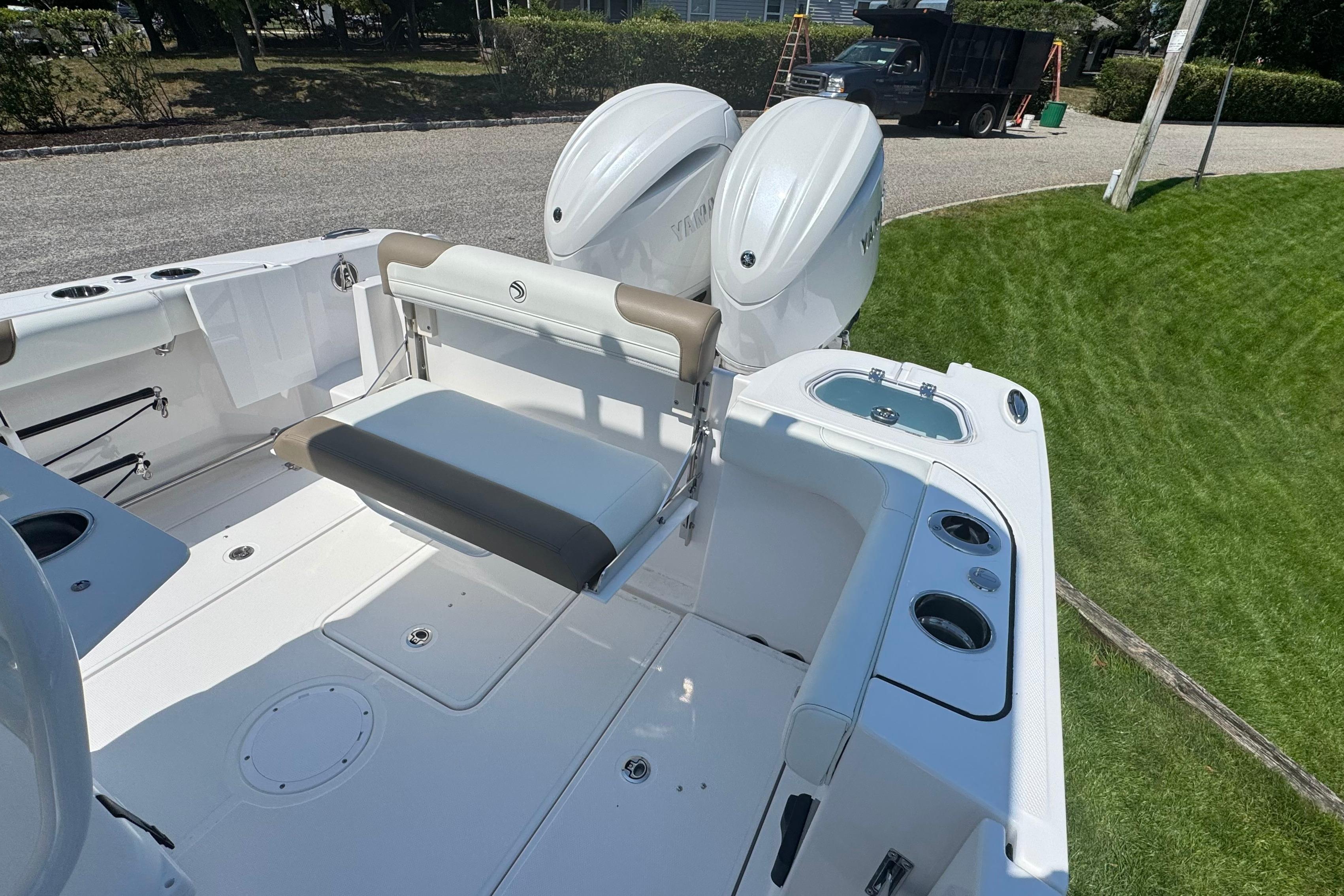 2026 Edgewater 250CC boat interior with seating and dual outboard motors.