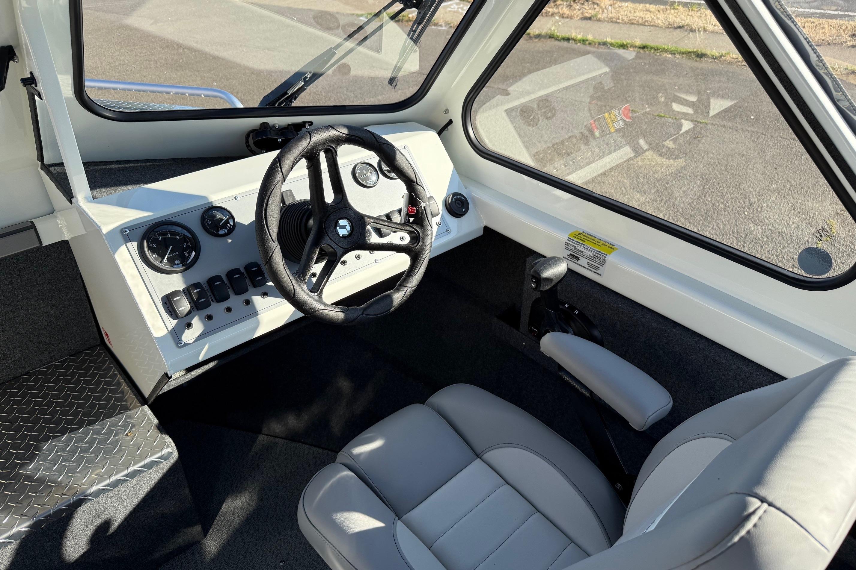 2026 Thunder Jet 185 Luxor boat interior with steering wheel and control panel.