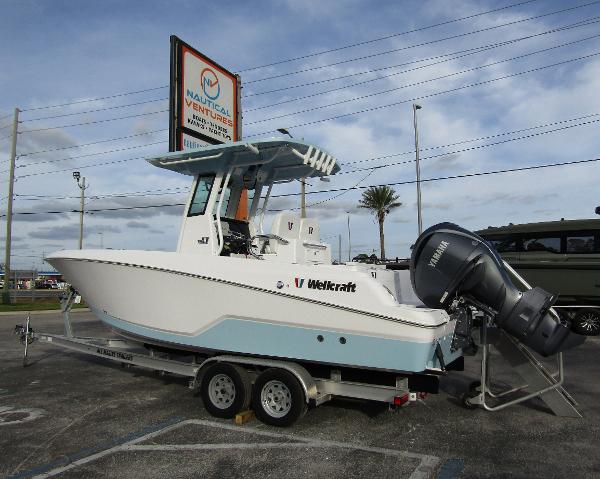 2025 Wellcraft 243 Fisherman boat on trailer at dealership.