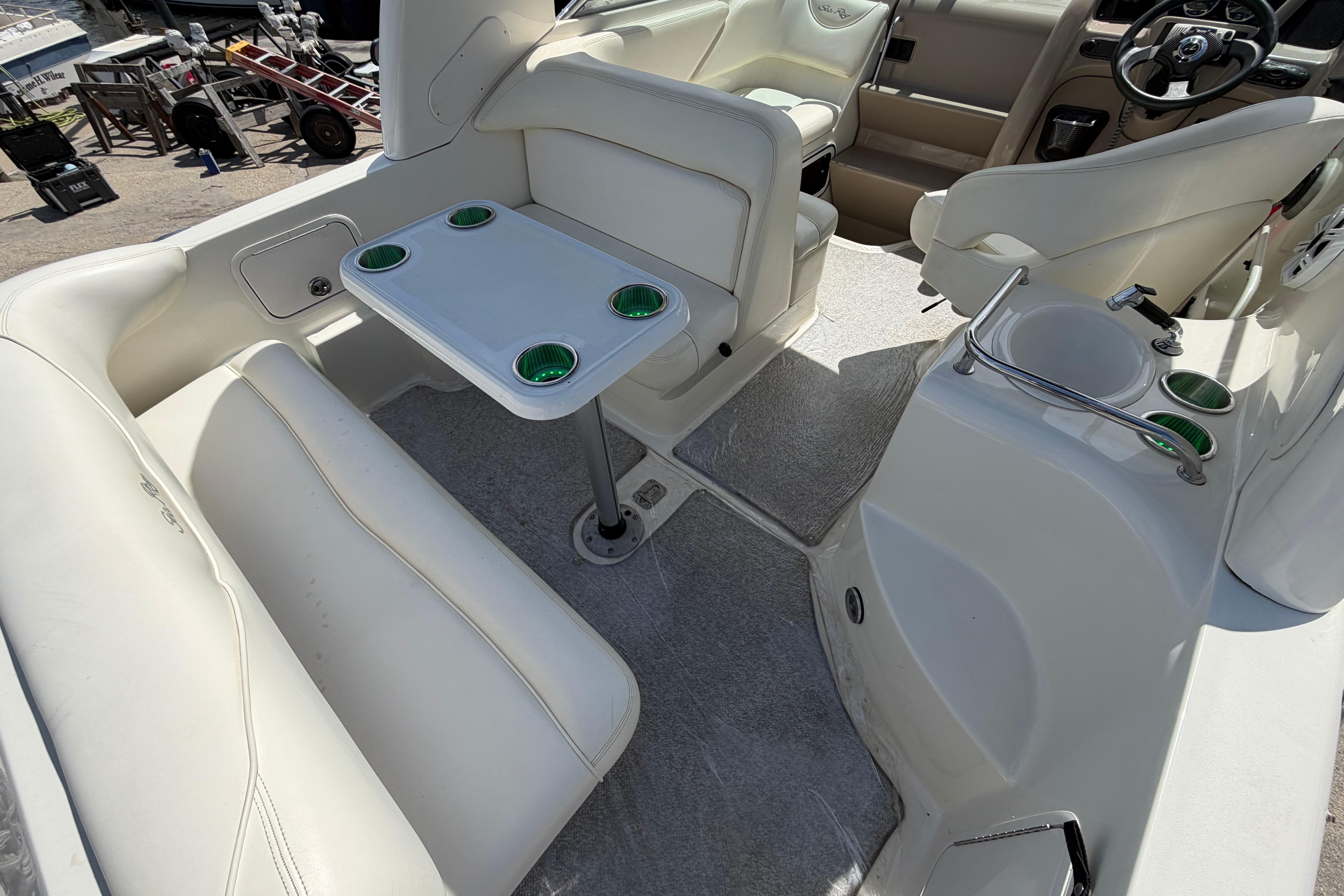 Interior of 2004 Sea Ray Sundancer 260 boat with seating and table setup.