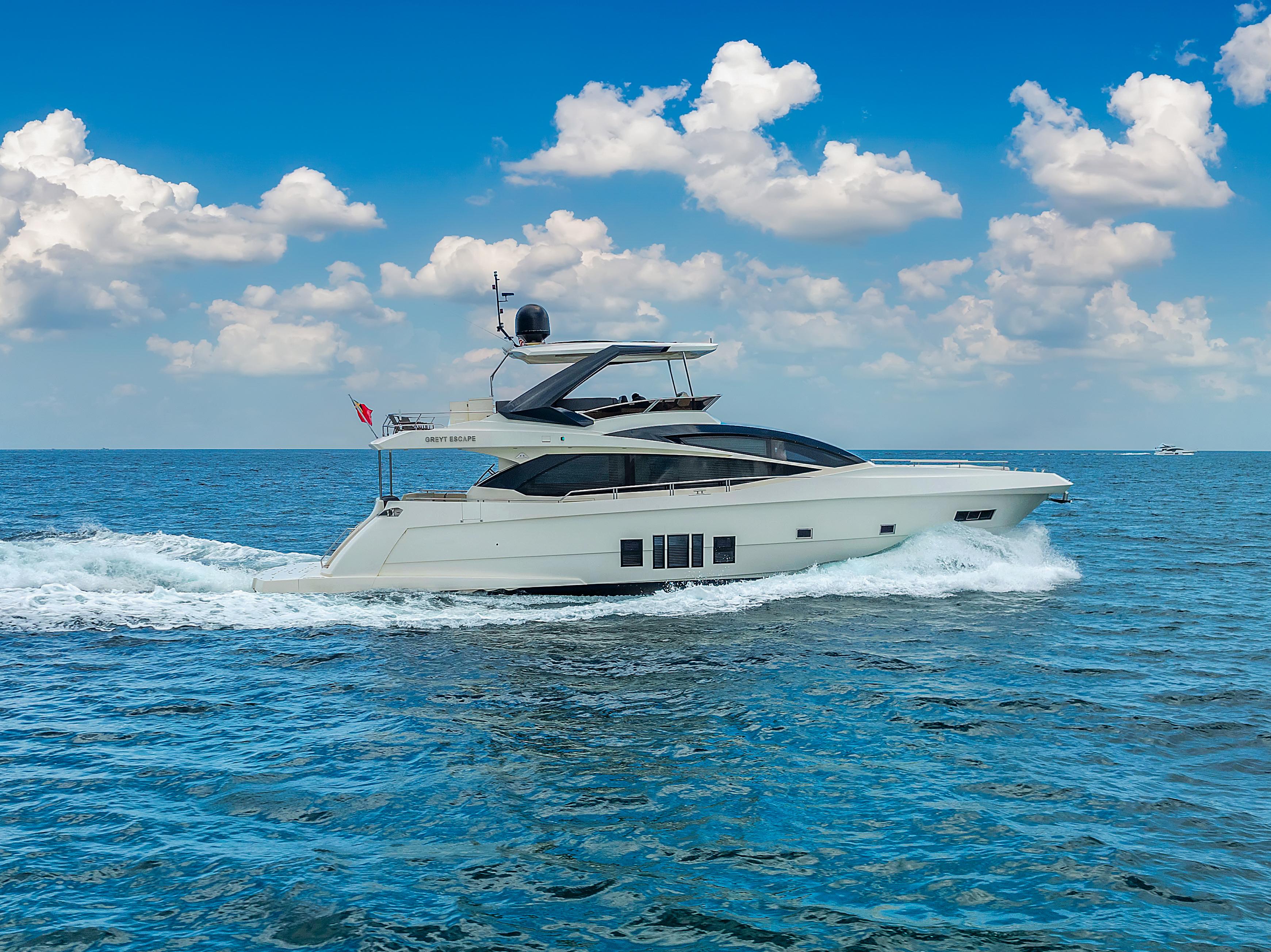 Luxury 2013 Astondoa 72 GLX yacht cruising on open sea under blue sky.