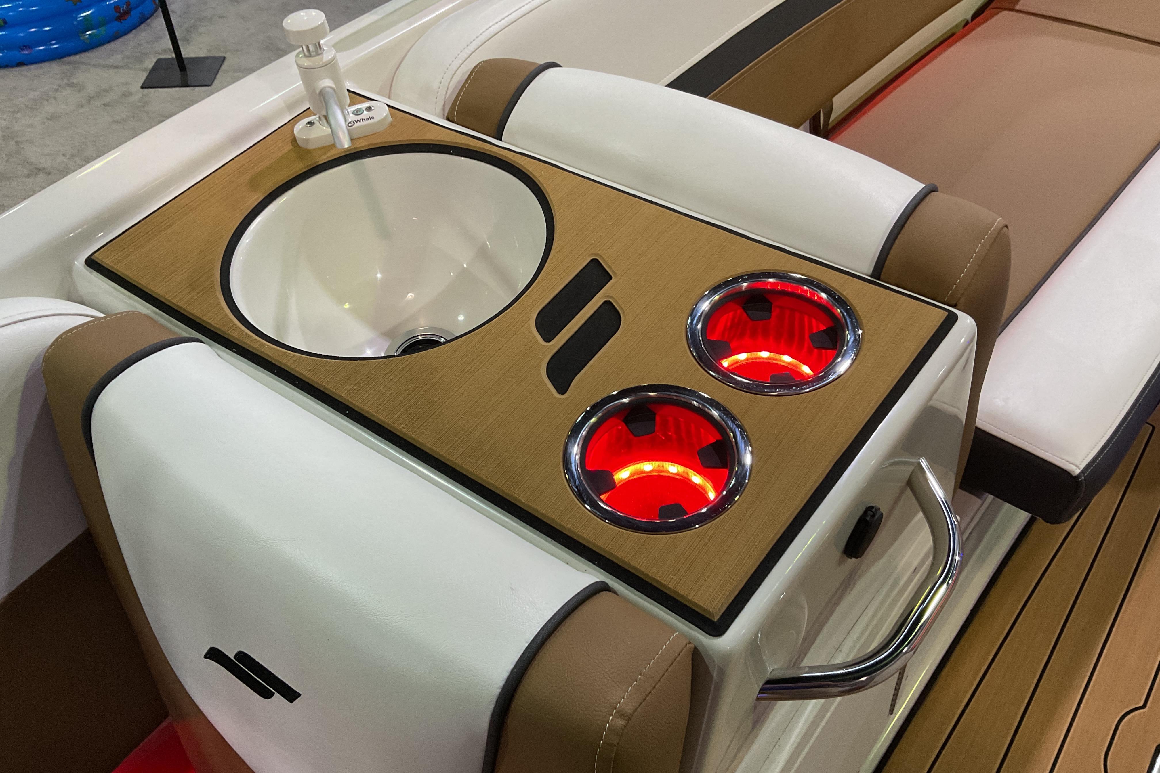 2026 Starcraft SVX 211 OB boat interior with sink and illuminated cup holders.